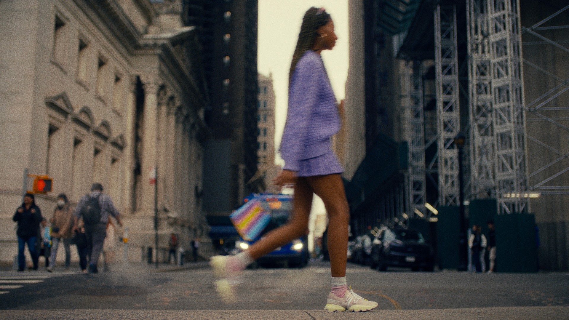 Alexis Williams whips past the camera in a stylish outfit through New York's Madison Park