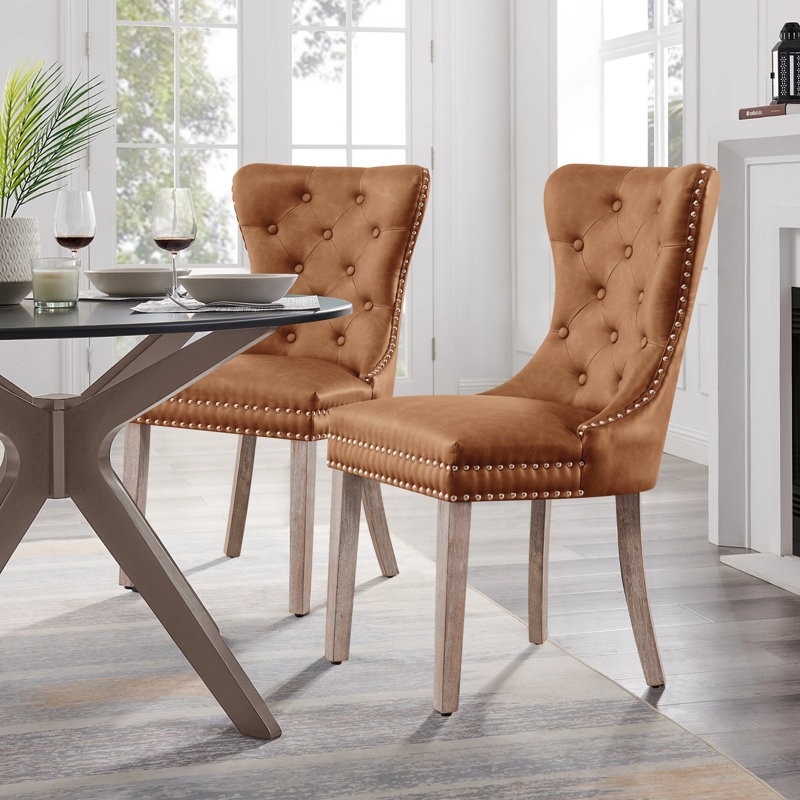 The leather wingback dining chair offers a sleek and contemporary look, ideal for productivity.