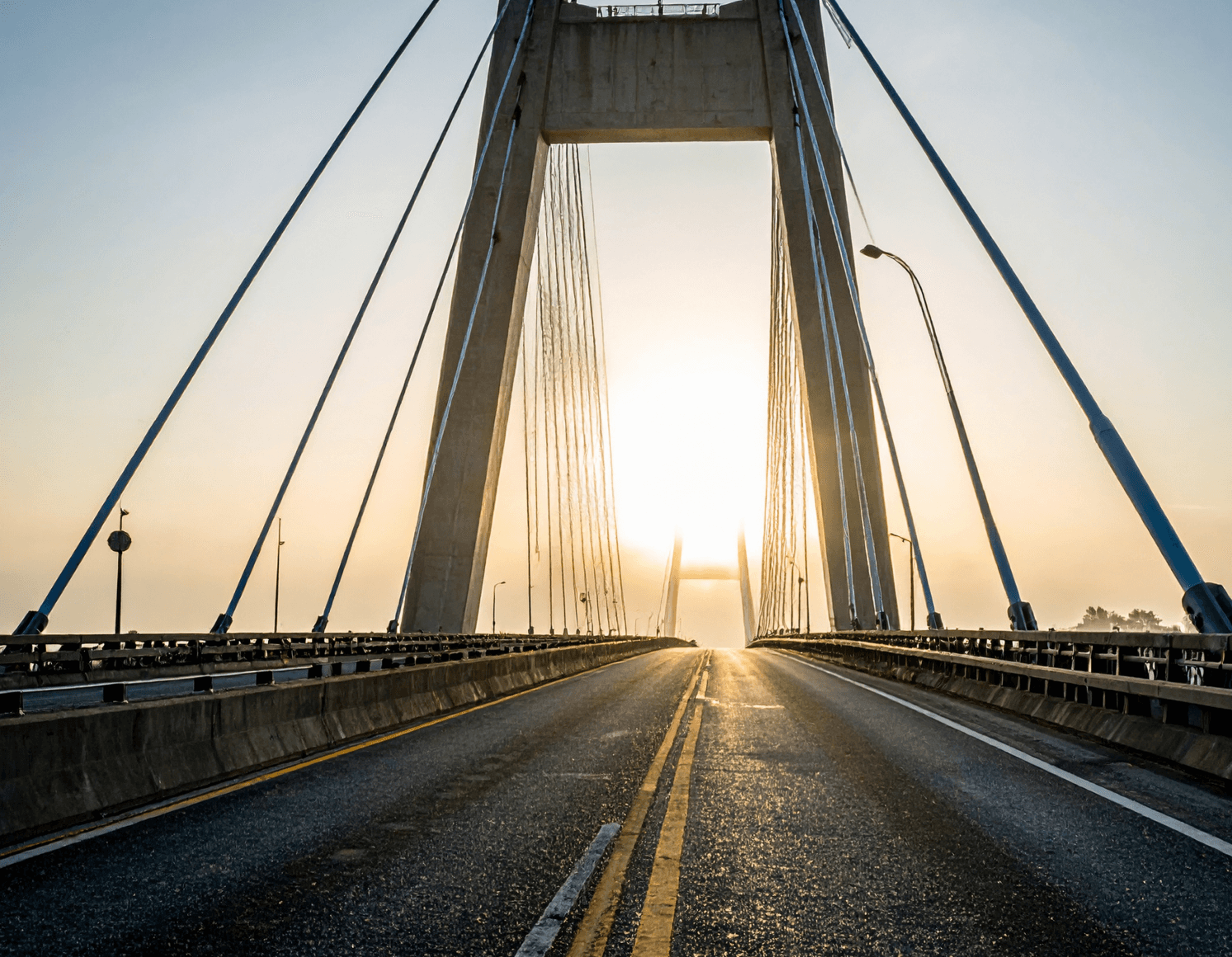 Silhouette of a researcher examining a slide under a microscope with a blue background.