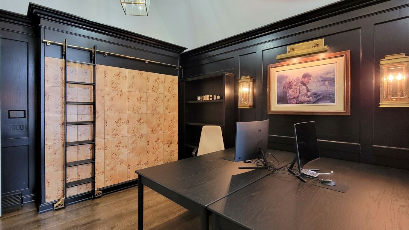 Image of Luxury office interior design with dark wood accents and elegant furniture by KHD Homes design-build.
