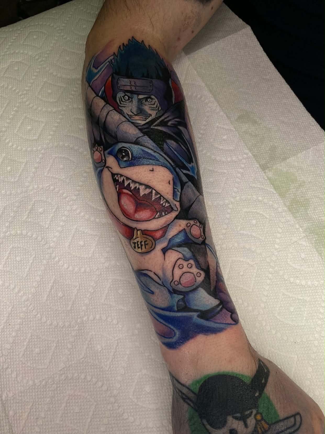 A forearm tattoo of Nezuko Kamado from Demon Slayer, depicted in a stylized anime art style. She is holding a sword.