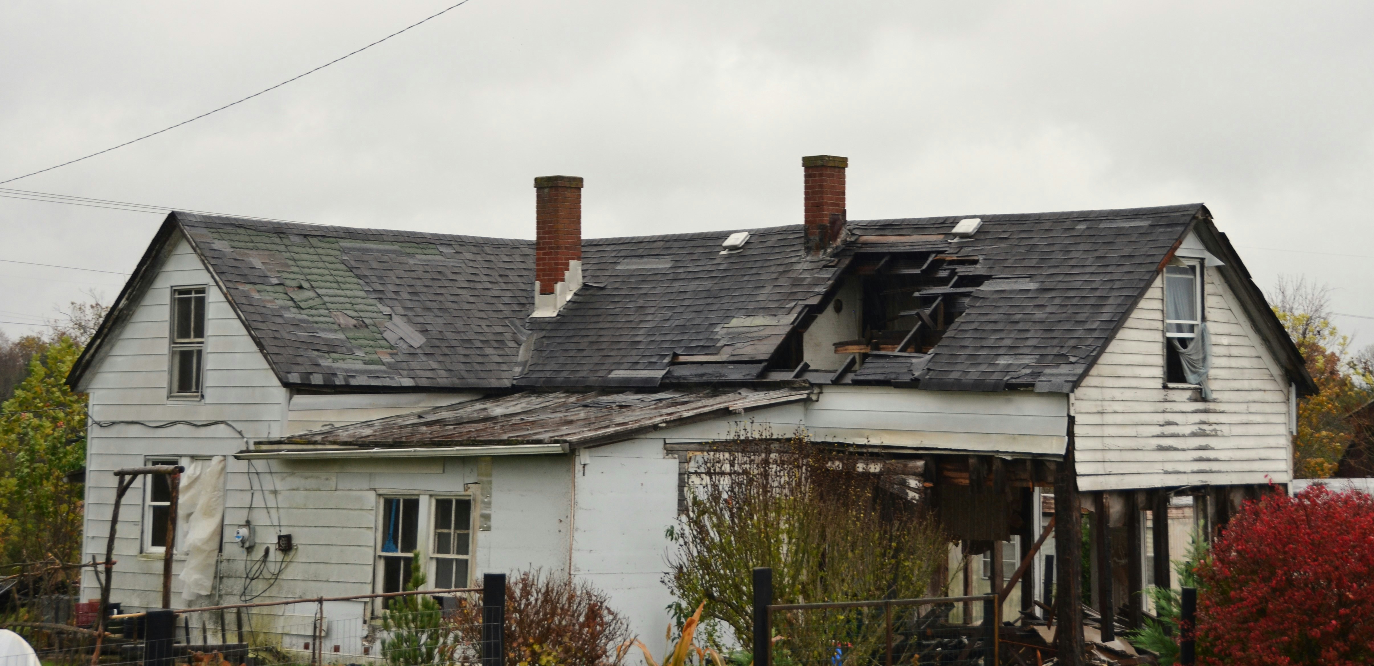 Dilapidated house with a damaged roof