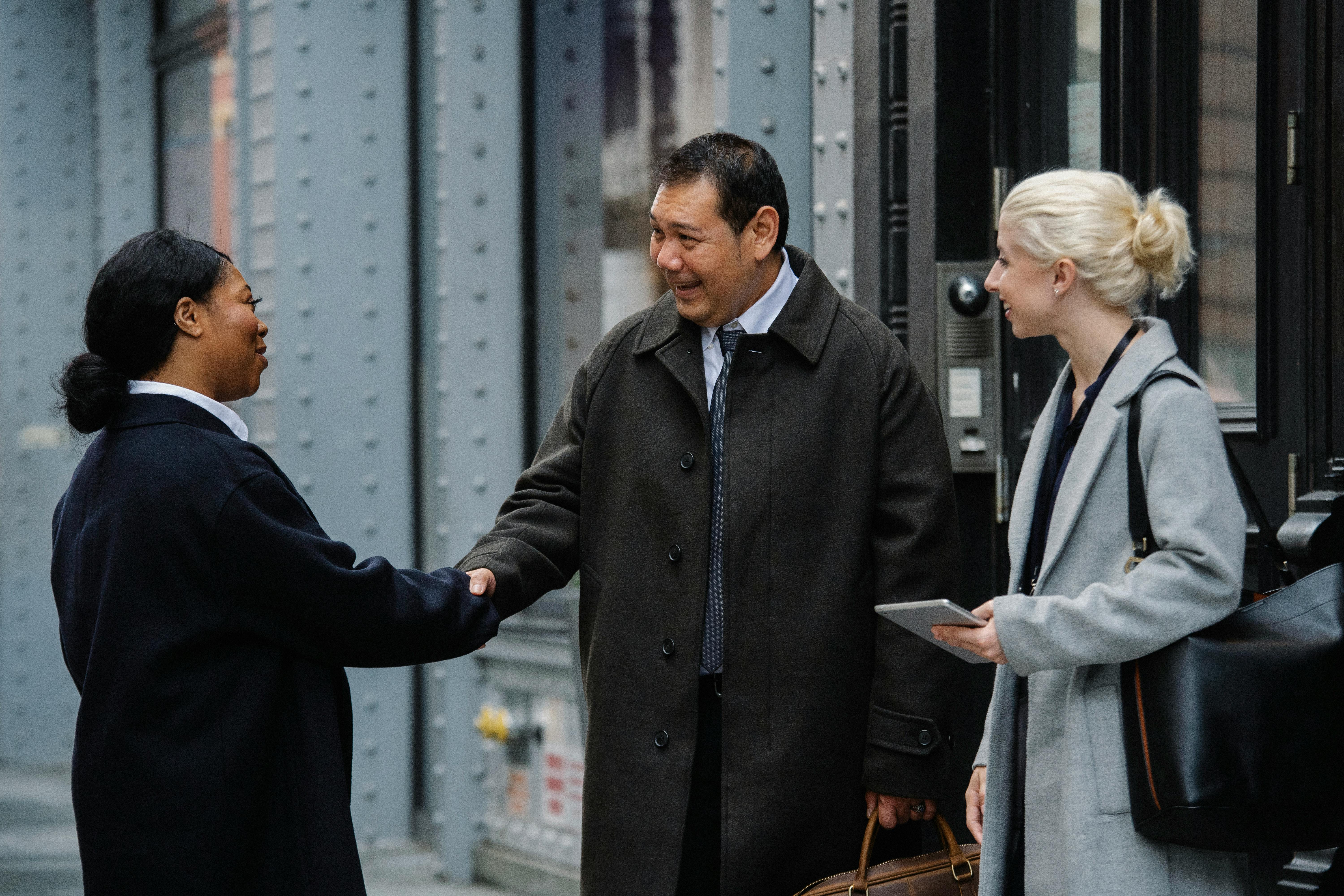 Mortgage broker shaking hands with his first client