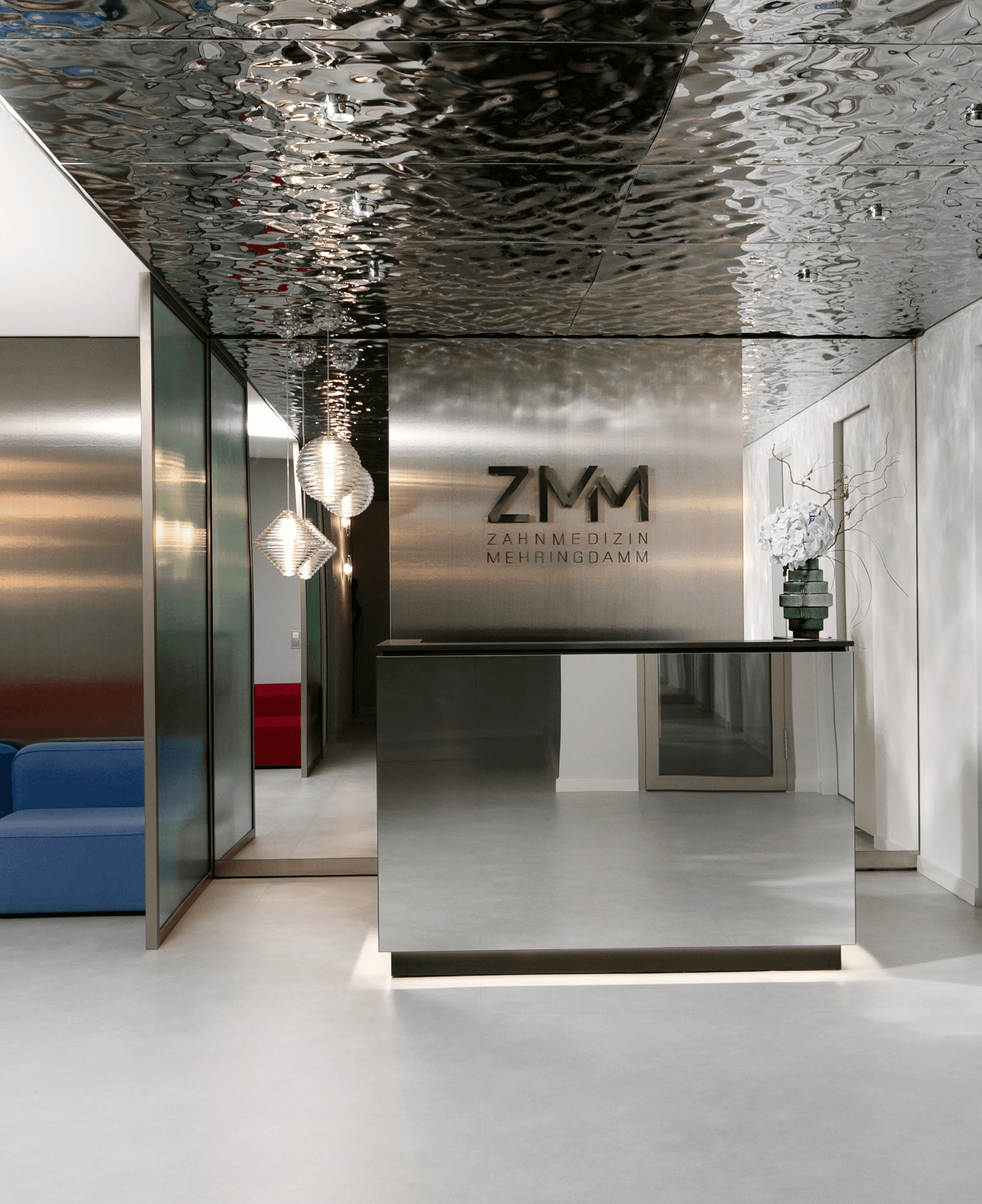 Portrait of a woman with short brown hair, eyes closed, gently holding her face