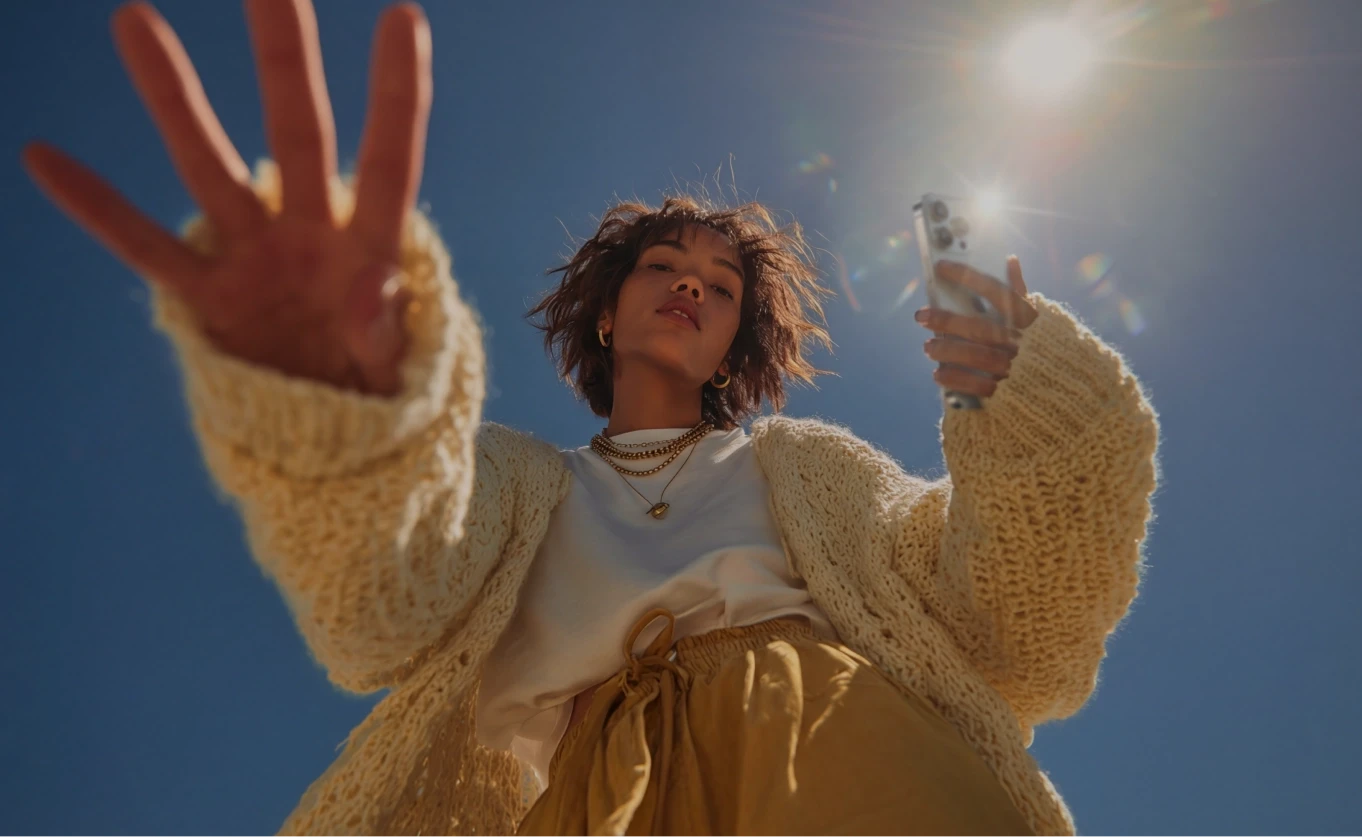 Person reaching toward camera against blue sky — editorial mood photo