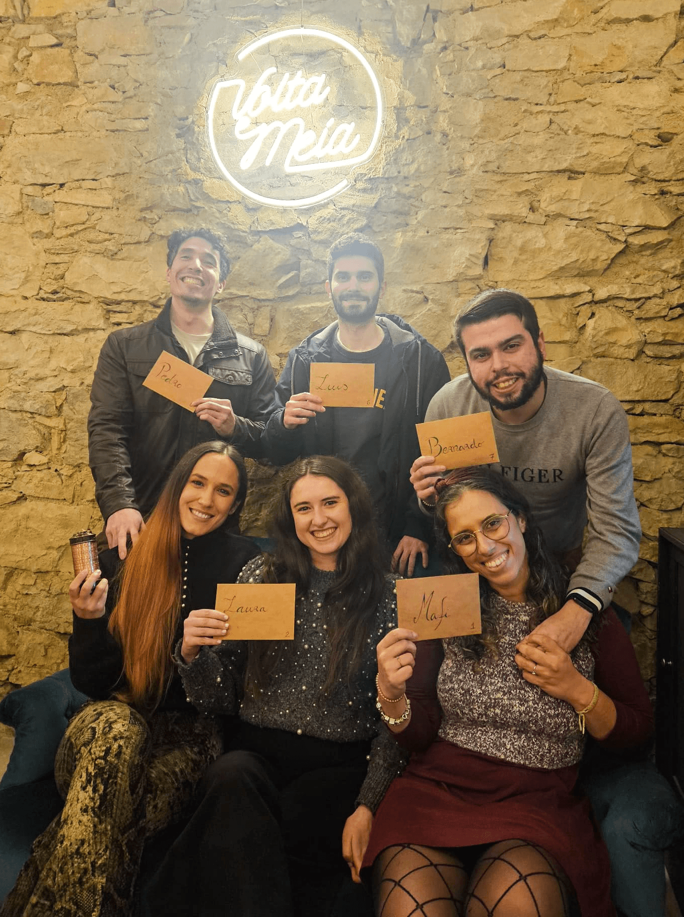 A woman lying down with a towel wrapped around her head, her face glistening with facial oil. Her eyes are closed, and she appears to be enjoying a spa treatment in a peaceful setting.
