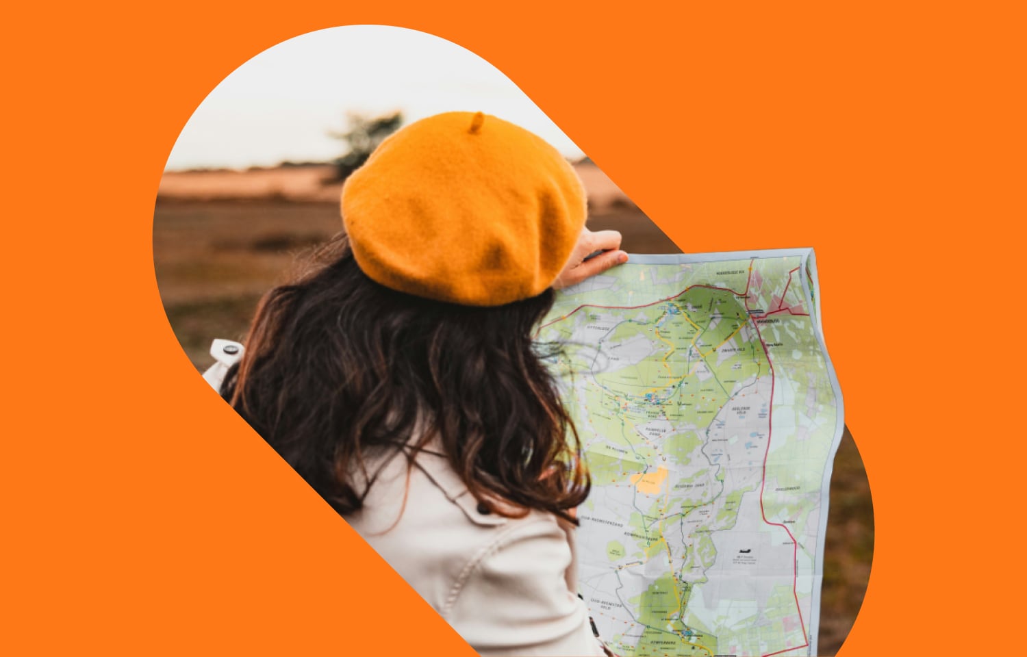 Woman wearing orange beret and reading a map