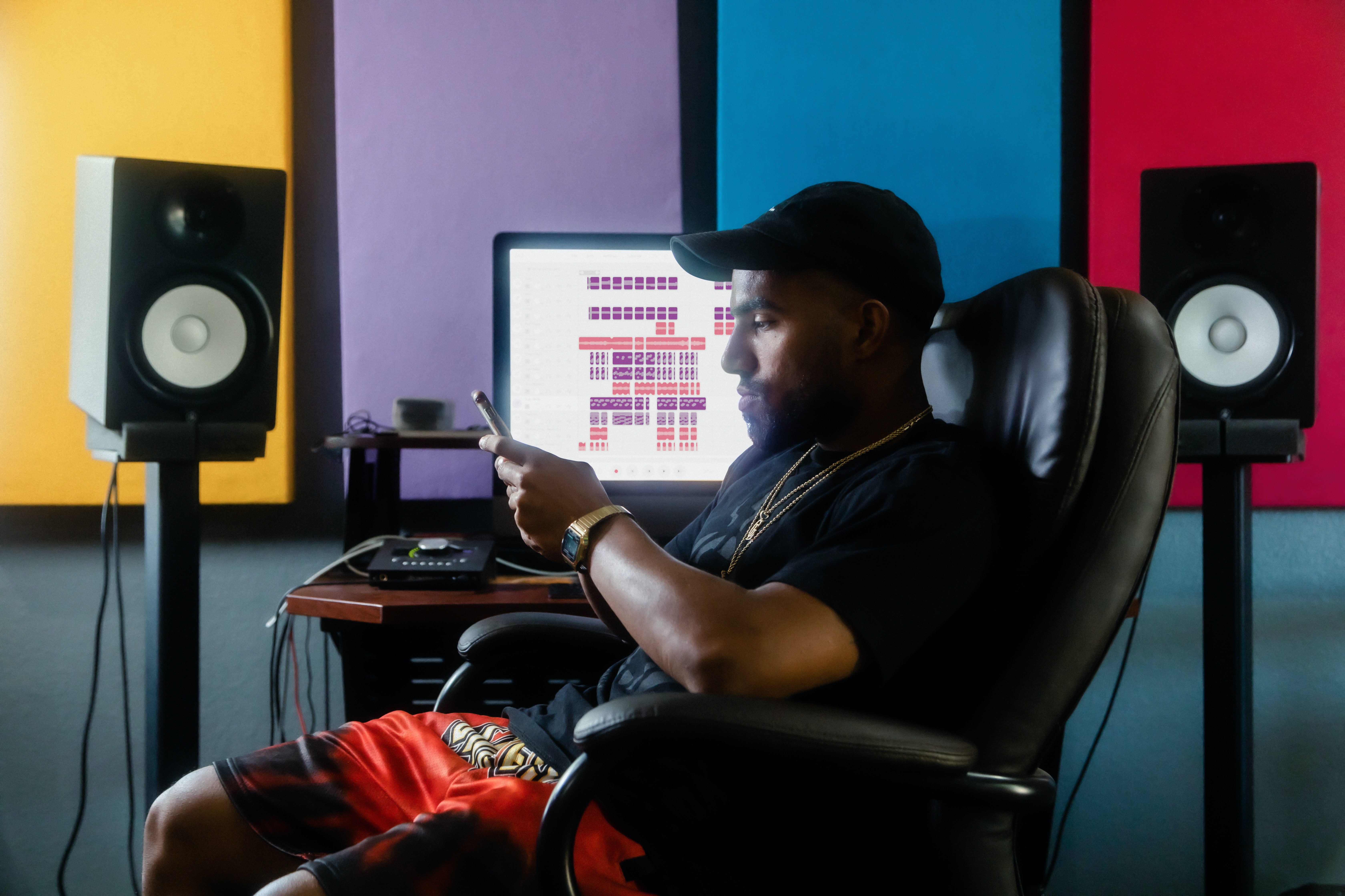 Singer looking through his phone after recording music - ai music tools