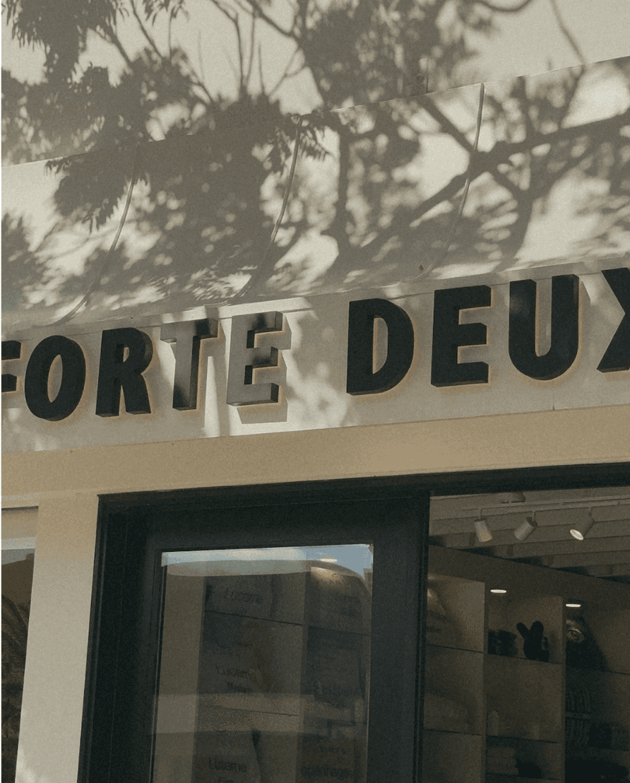 Backlit storefront signage for Forte Deux fashion boutique designed for a minimalist retail façade.