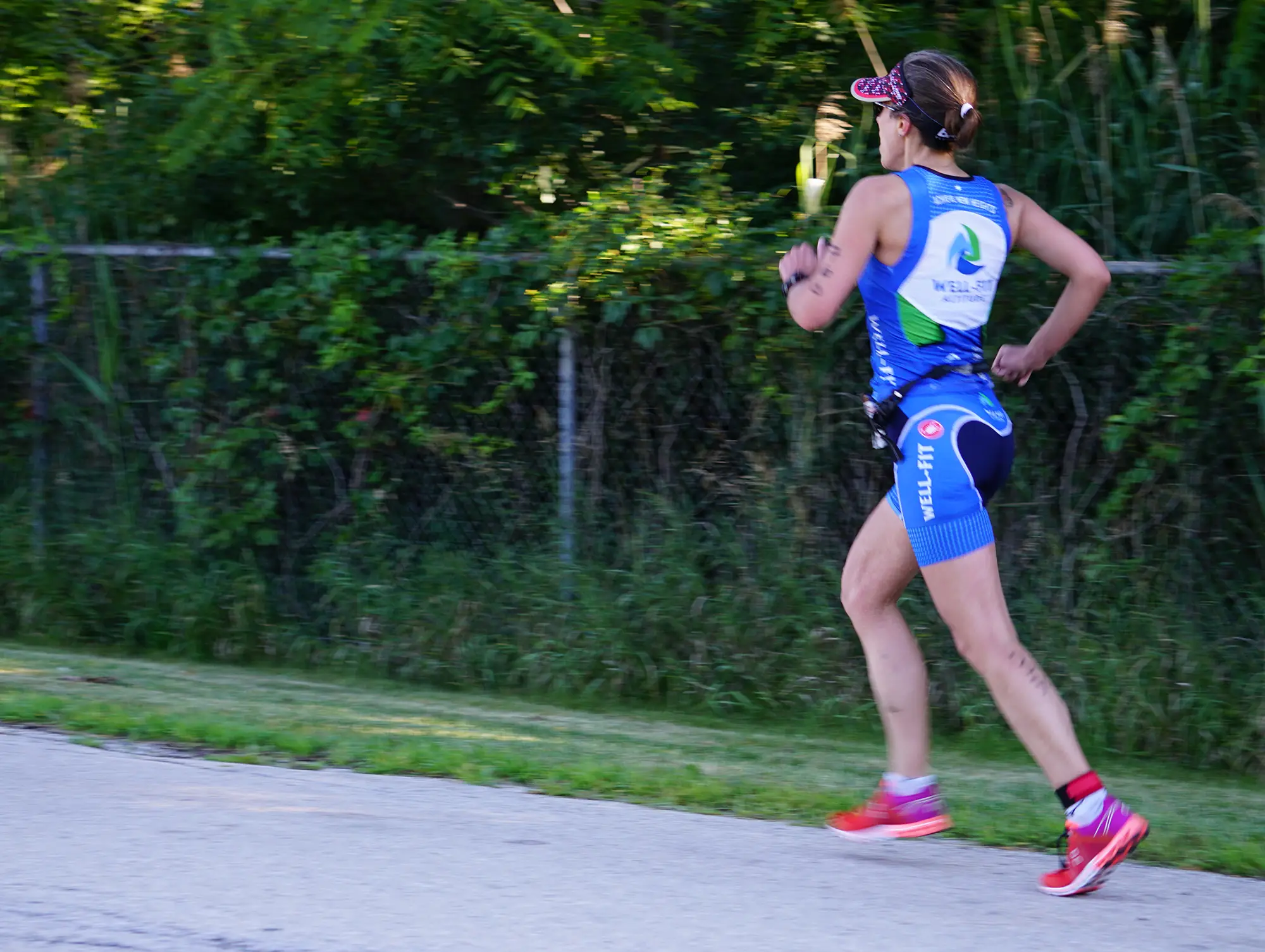 Well-Fit athlete running in a blue Well-Fit Multisport tri kit during a triathlon training session in Chicago