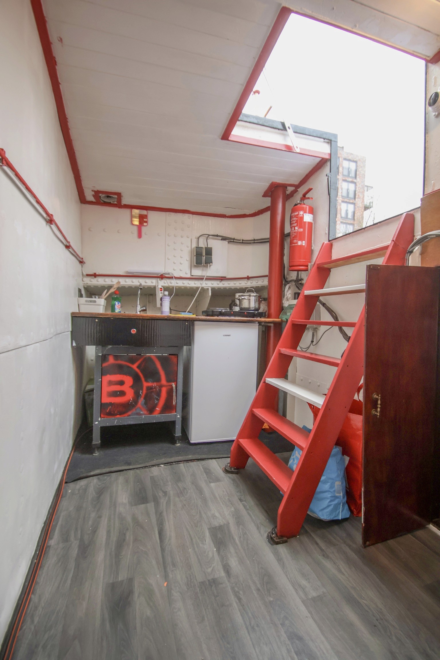 Grey marble bathroom with round mirror and floating sink