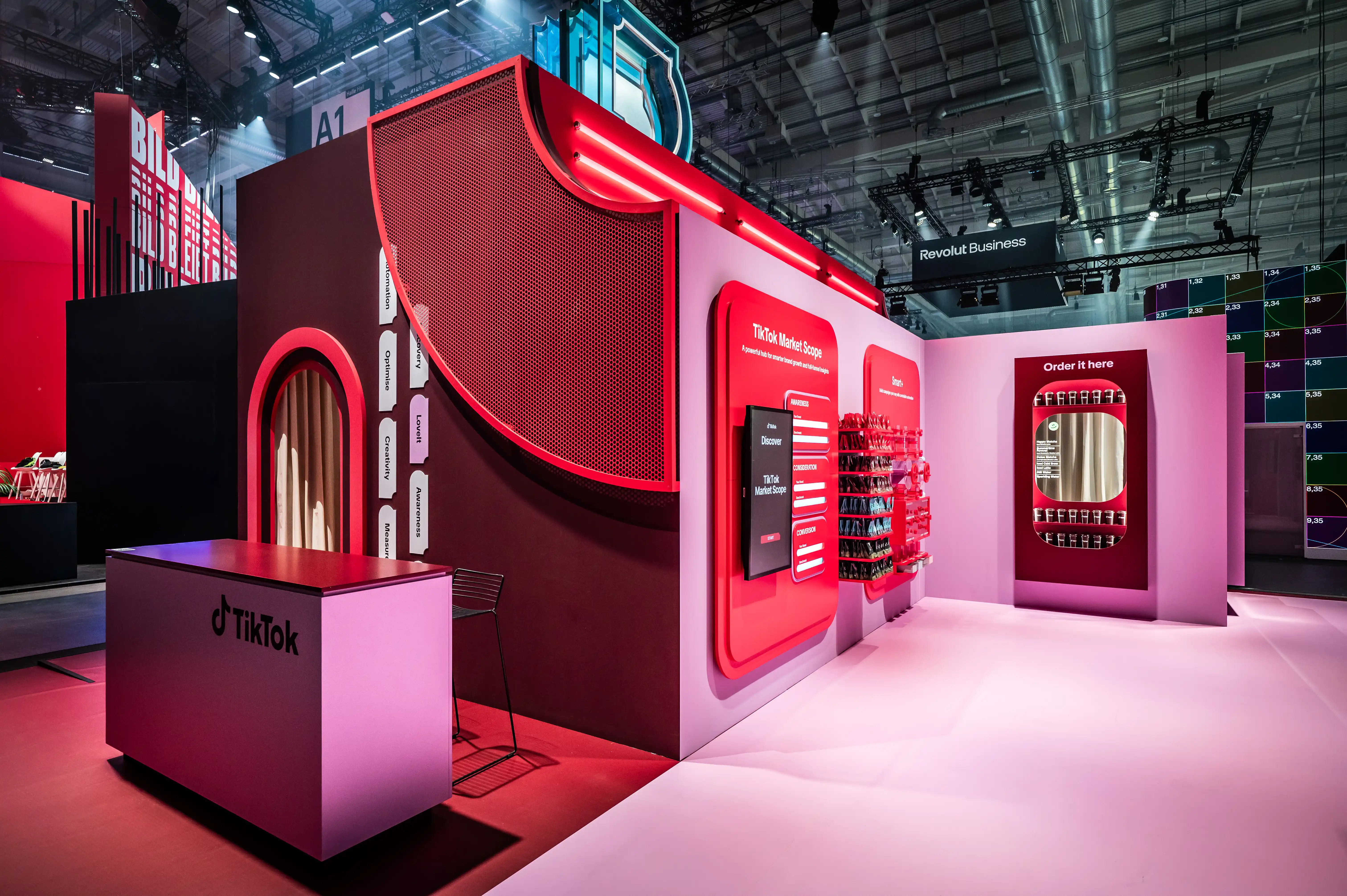Pink and red TikTok booth corner with counter, Market Scope wall and Order it here mirror display.