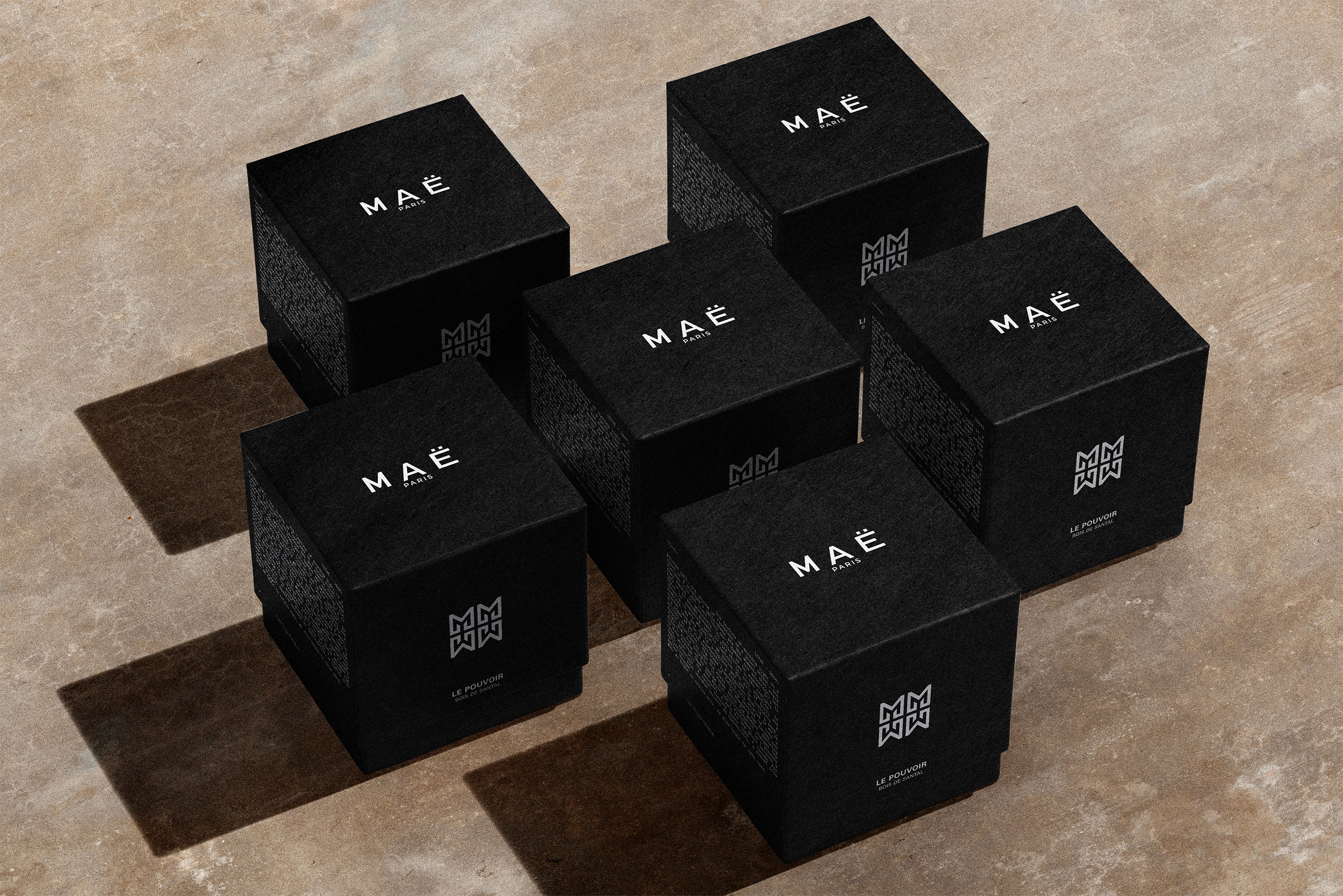 MAË PARIS luxury packaging with black product boxes arranged in a premium branding mockup