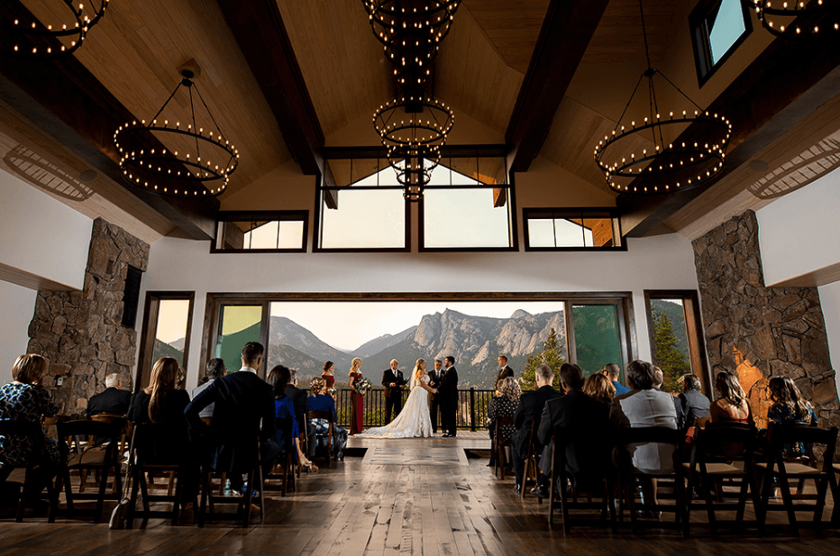 Wedding ceremony at Black Canyon Inn with mountain views in Estes Park, Colorado.