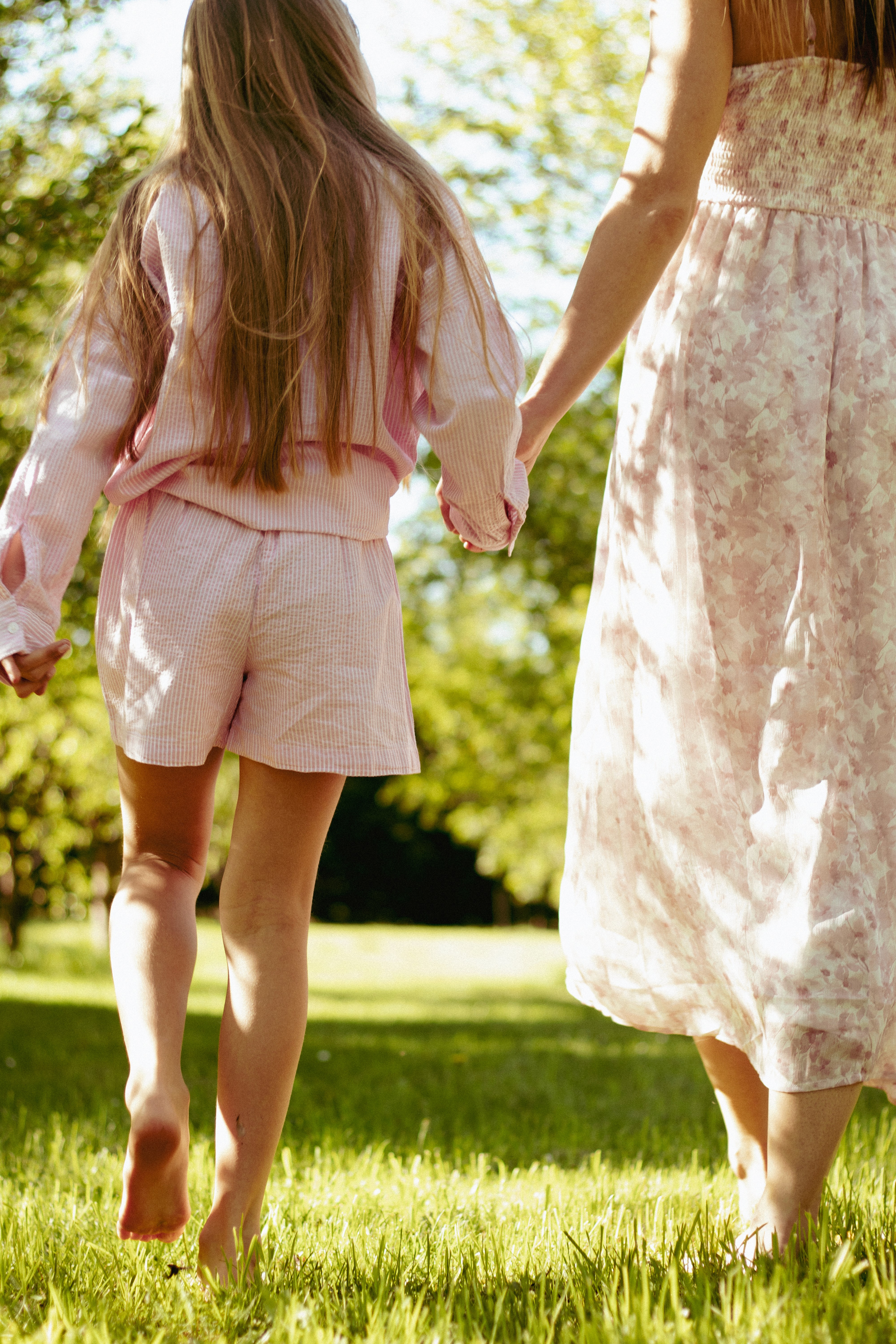 man in white shirt carrying girl in gray shirt