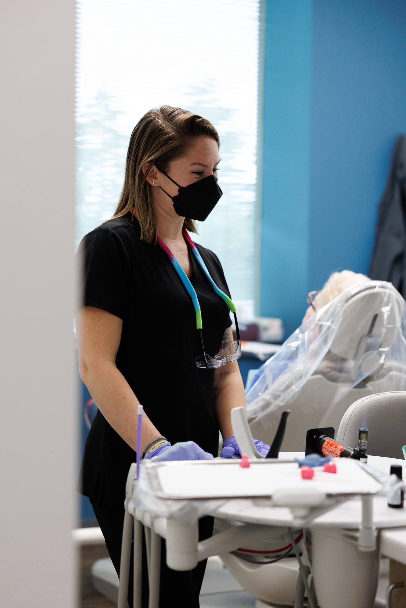 Supportive dental team comforting a nervous patient during an emergency visit