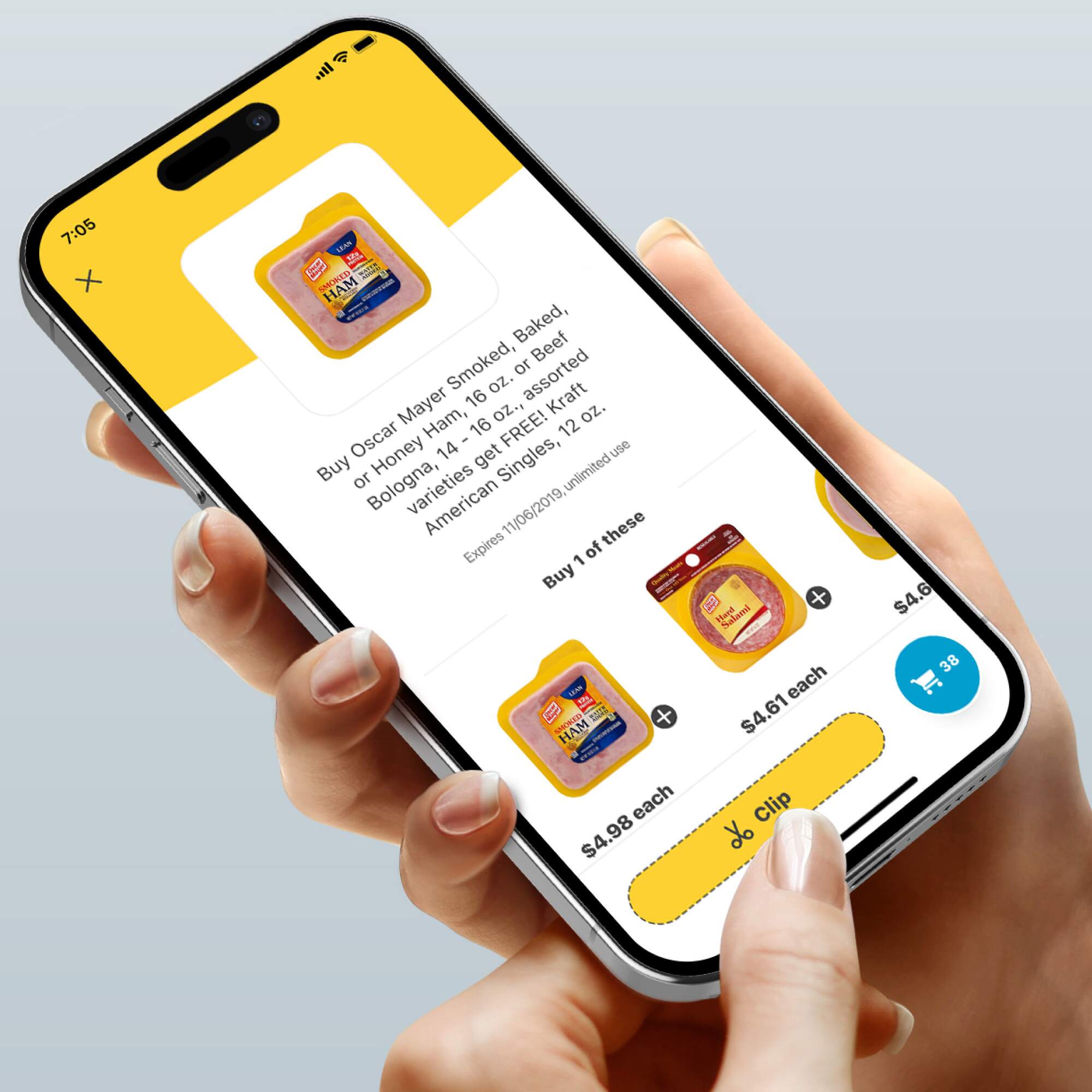 Hand holding a smartphone displaying the H-E-B app with a coupon for Oscar Mayer ham, highlighting product details and clipping options.