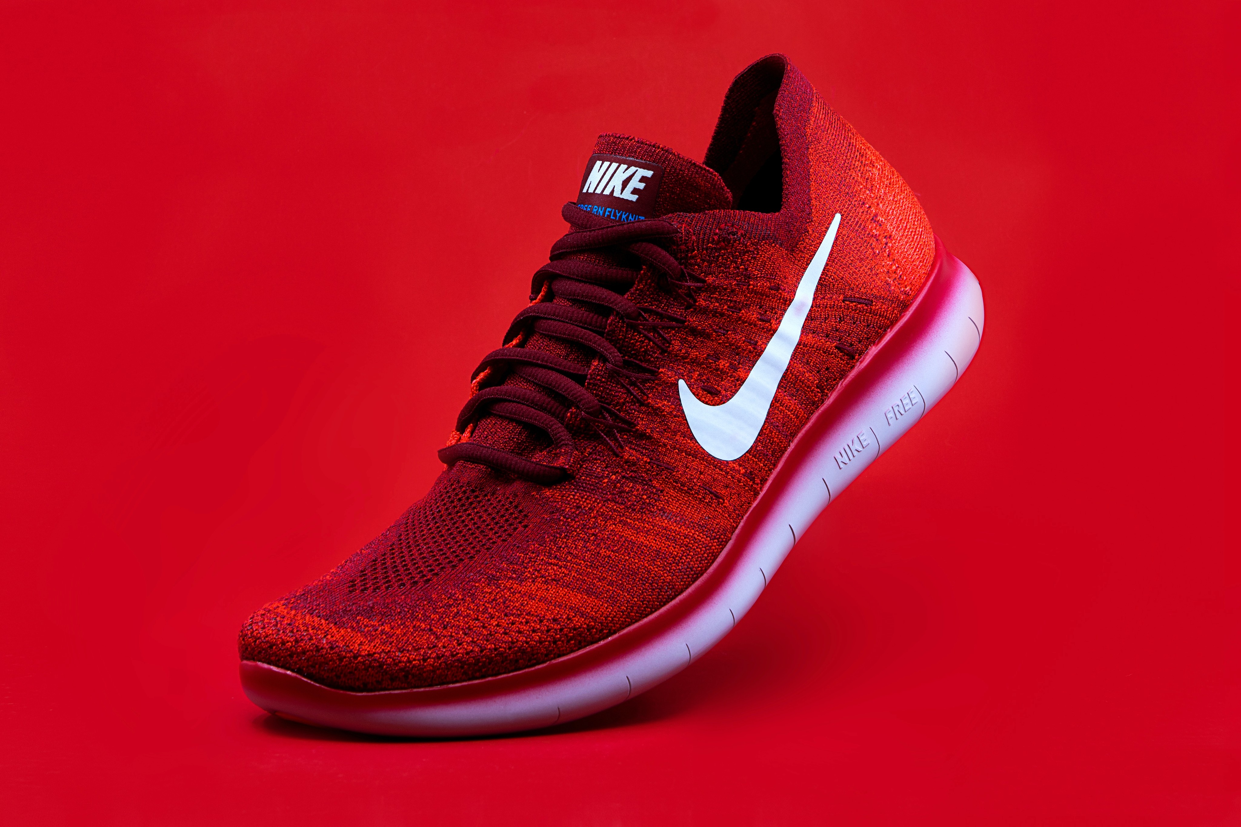 a red nike shoe on red background