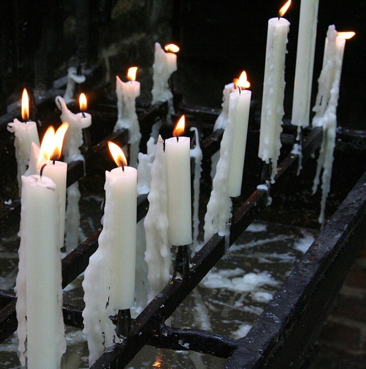 A row of lit white candles, representing the fire element