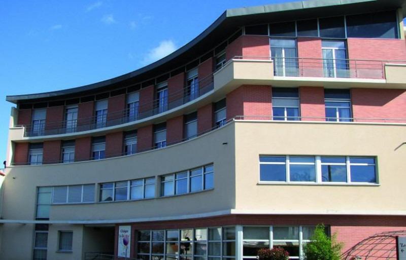 Modern clinical facility with a curved blue-tinted glass façade and multi-storey contemporary architecture