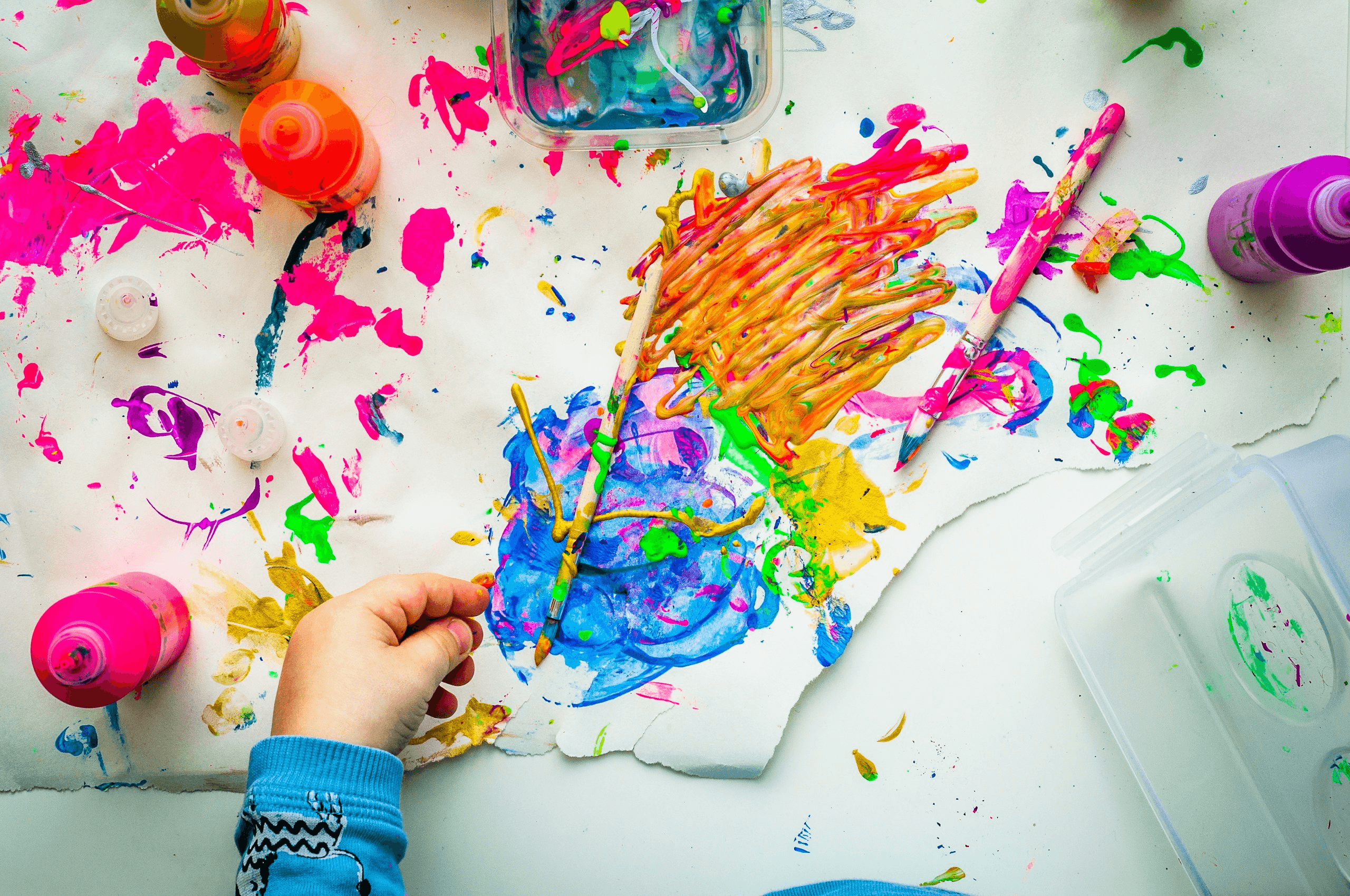 Child creating colorful messy paint artwork - Types Of Creativity