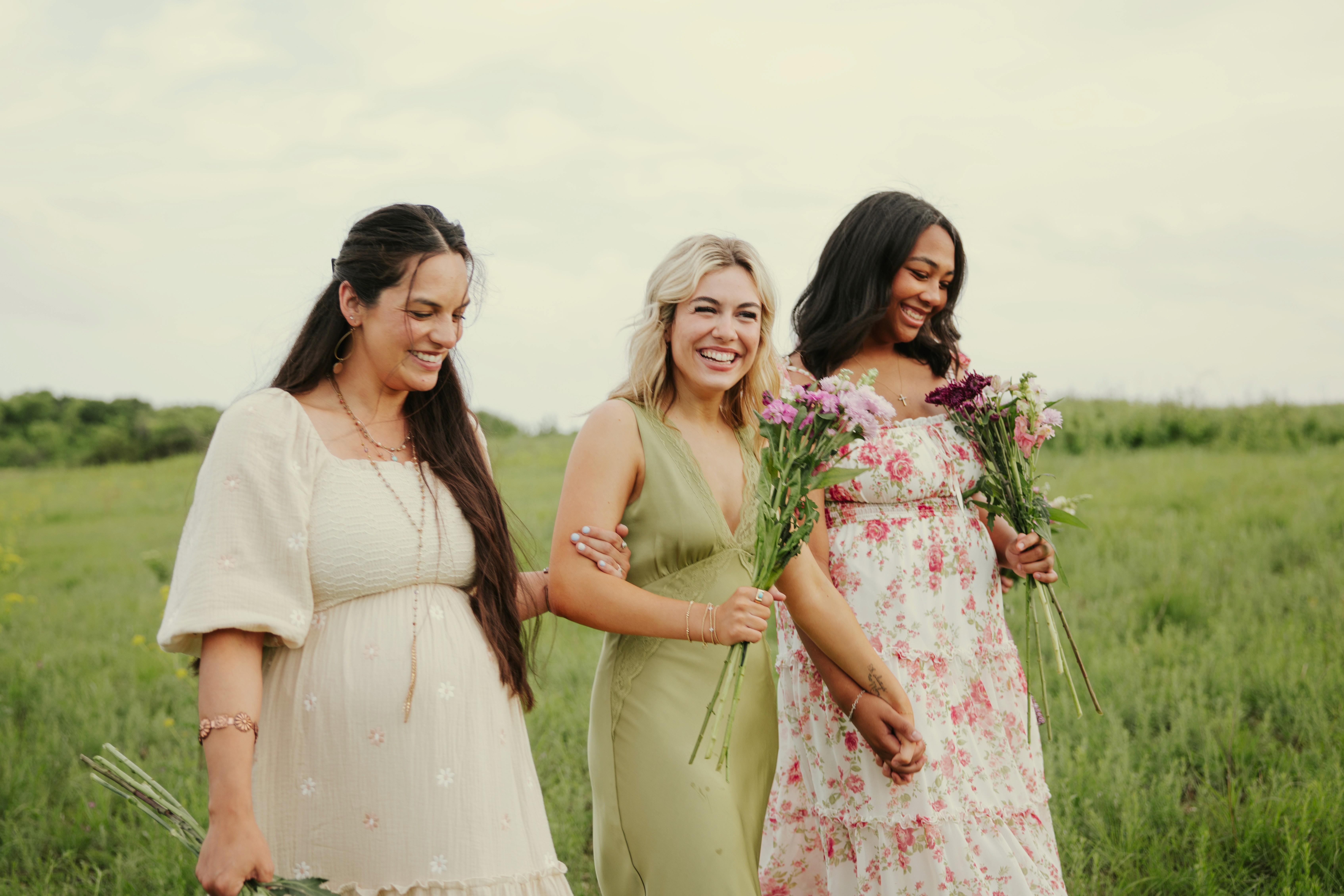 A performer sits at a piano under a single spotlight in a darkened space, creating an intimate atmosphere.
