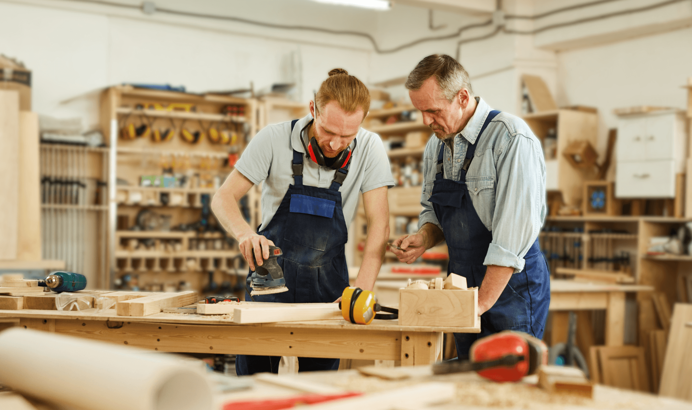 tutor overseeing delegate during carpentry training course