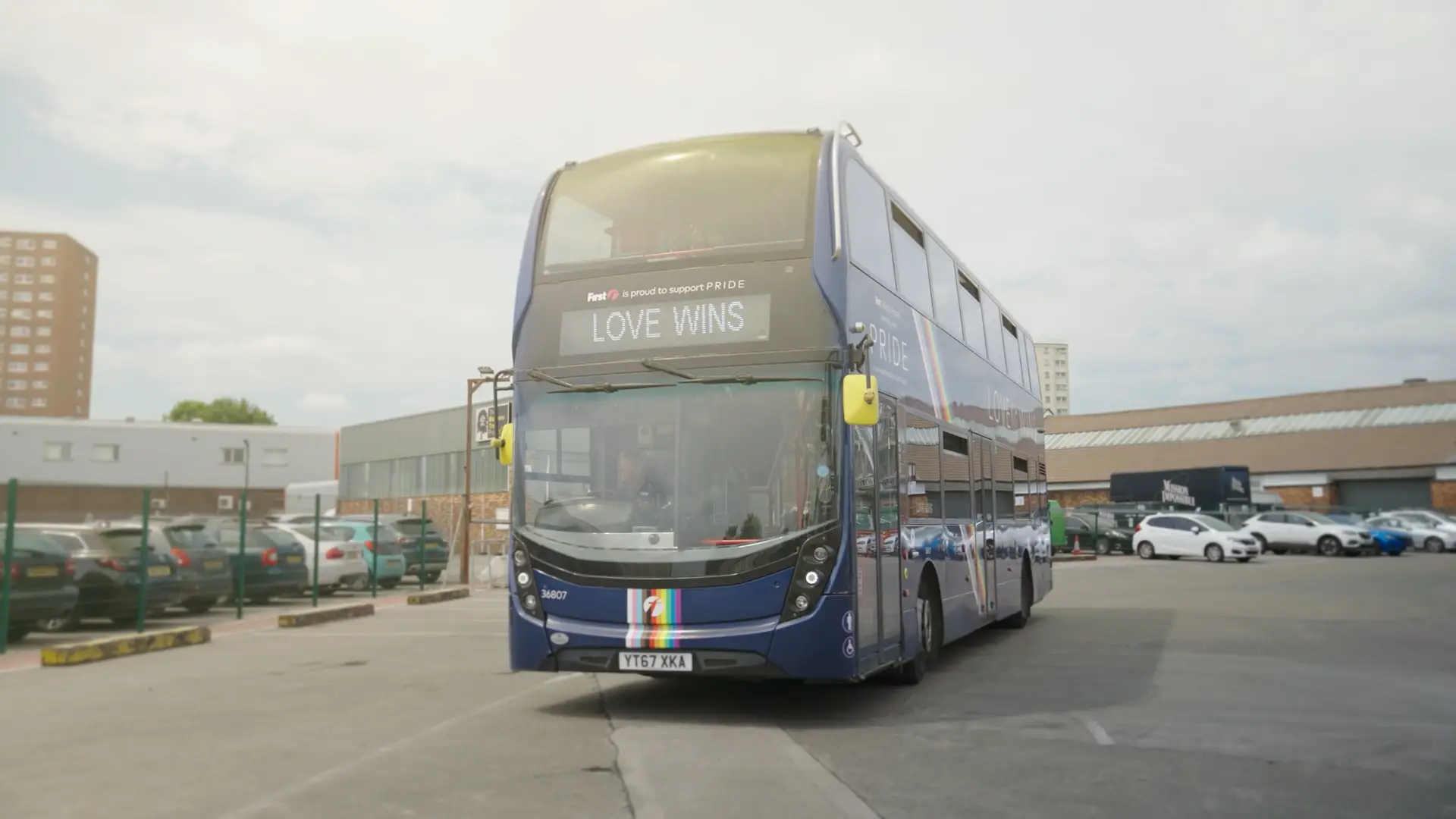 Group of presenters speaking on camera during a Microsoft live broadcast, filmed against branded event graphics.