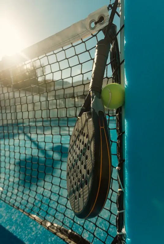 Smiling young Asian woman with long black hair, wearing a brown turtleneck against a neutral gray background. Warm and approachable vibe.