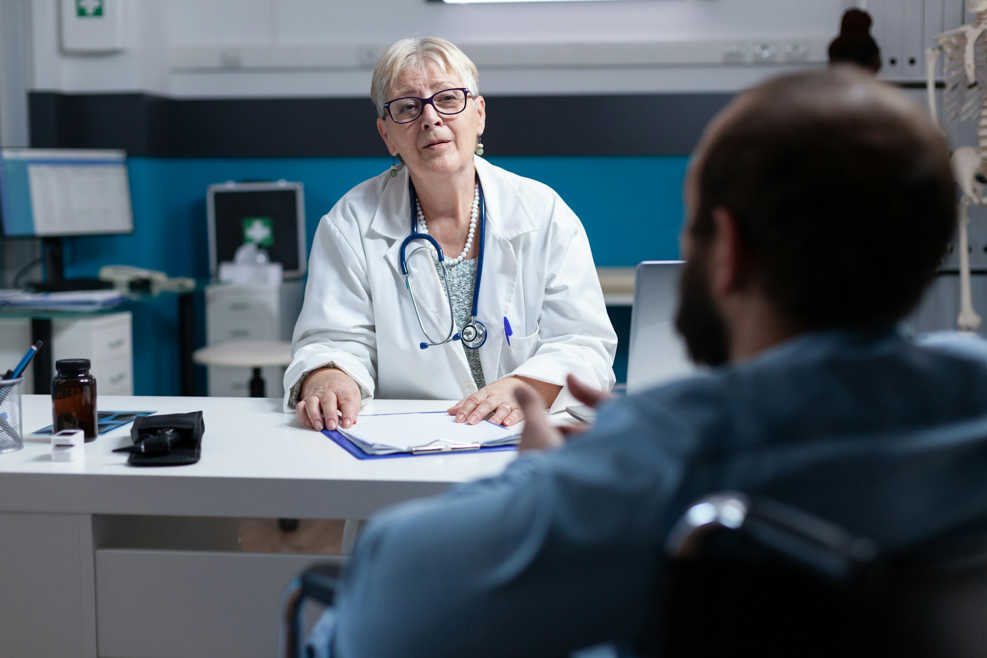 A patient and a doctor sitting in an office having a conversation