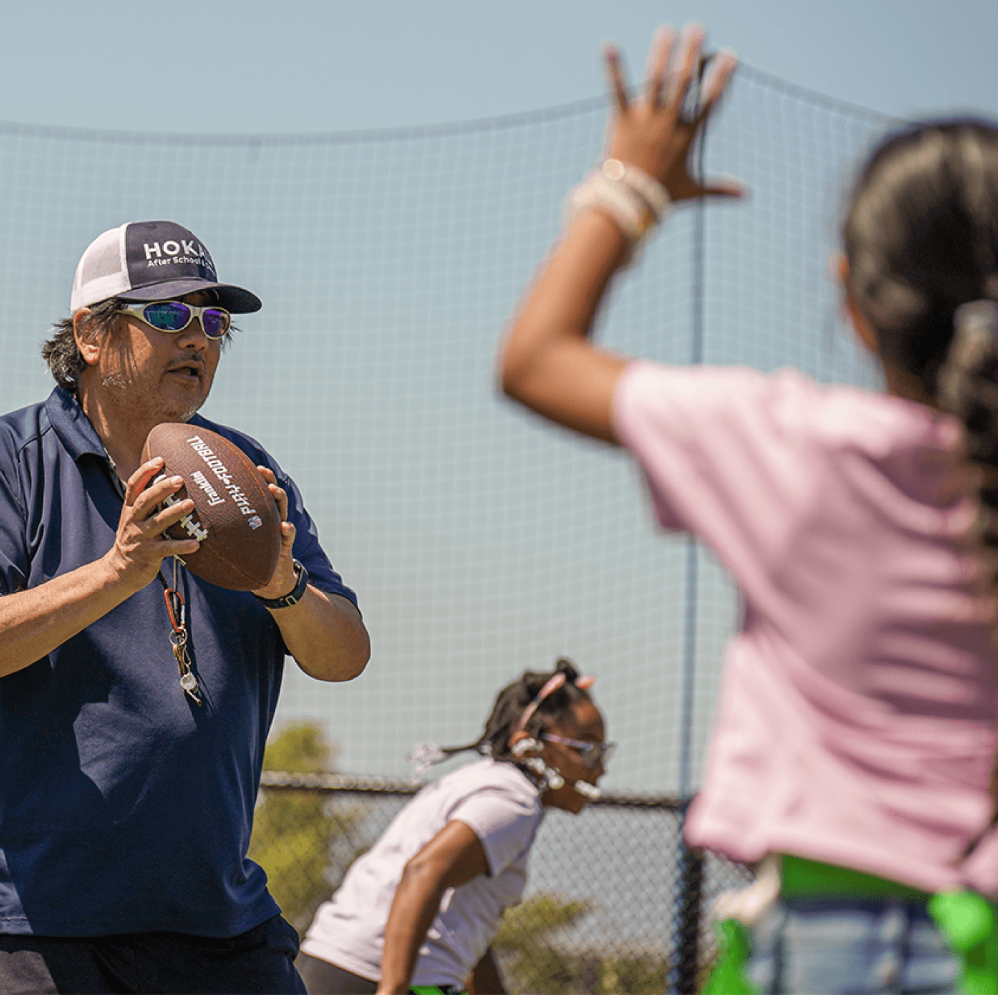 HOKALI summer camp instructor engaging kids in an active outdoor play session