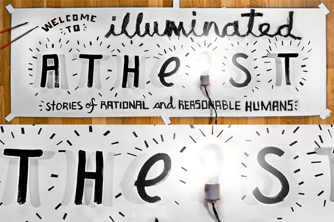The image shows two white signs with black handwritten text. The top sign reads “Welcome to Illuminated Athes Stories of Rational and Reasonable Humans.” The bottom sign reads “Illuminated Thes Stories of Rational and Reasonable Humans.” Both signs are hung on a wooden wall with black tape at the top and bottom. A single lightbulb is visible between the two signs, illuminating part of the bottom sign.