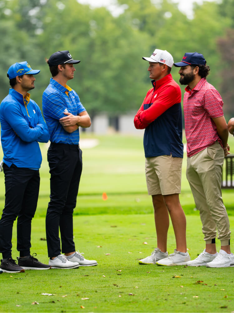 Two toddlers in puffy jackets playing in the snow.