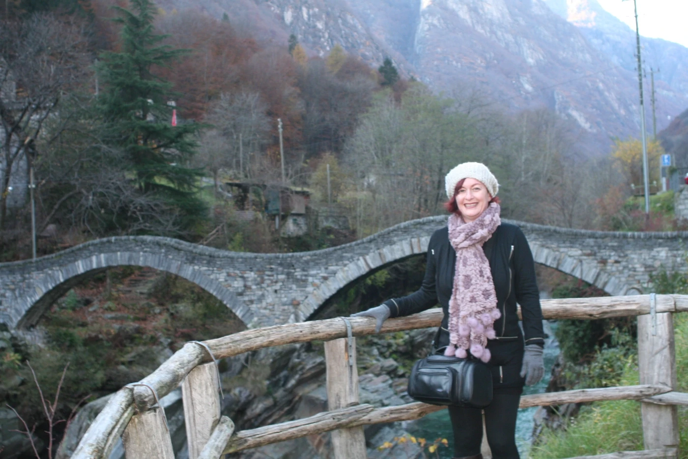 Author staning infront of a bridge and moutains in Ireland