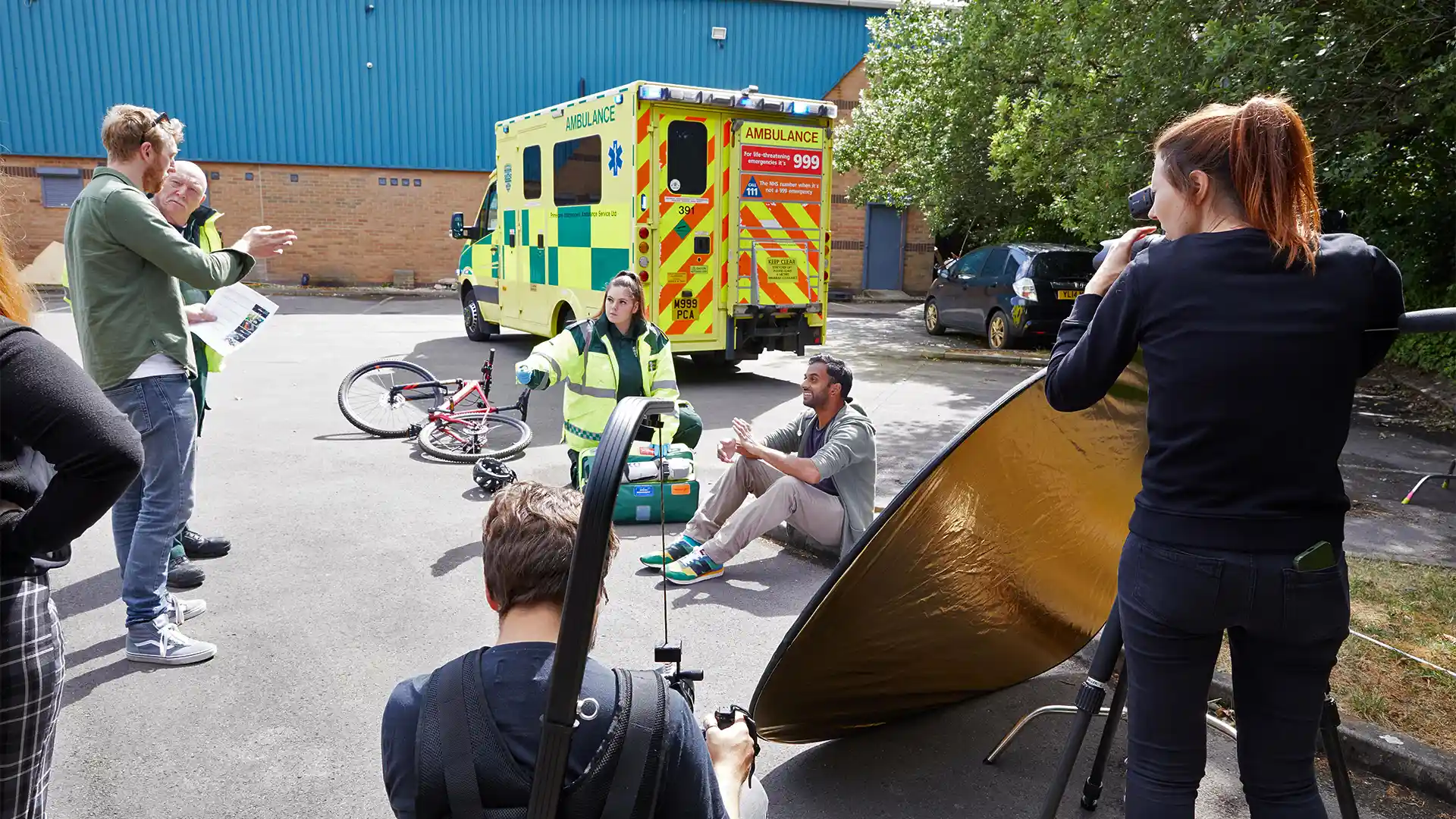 Group of presenters speaking on camera during a Microsoft live broadcast, filmed against branded event graphics.