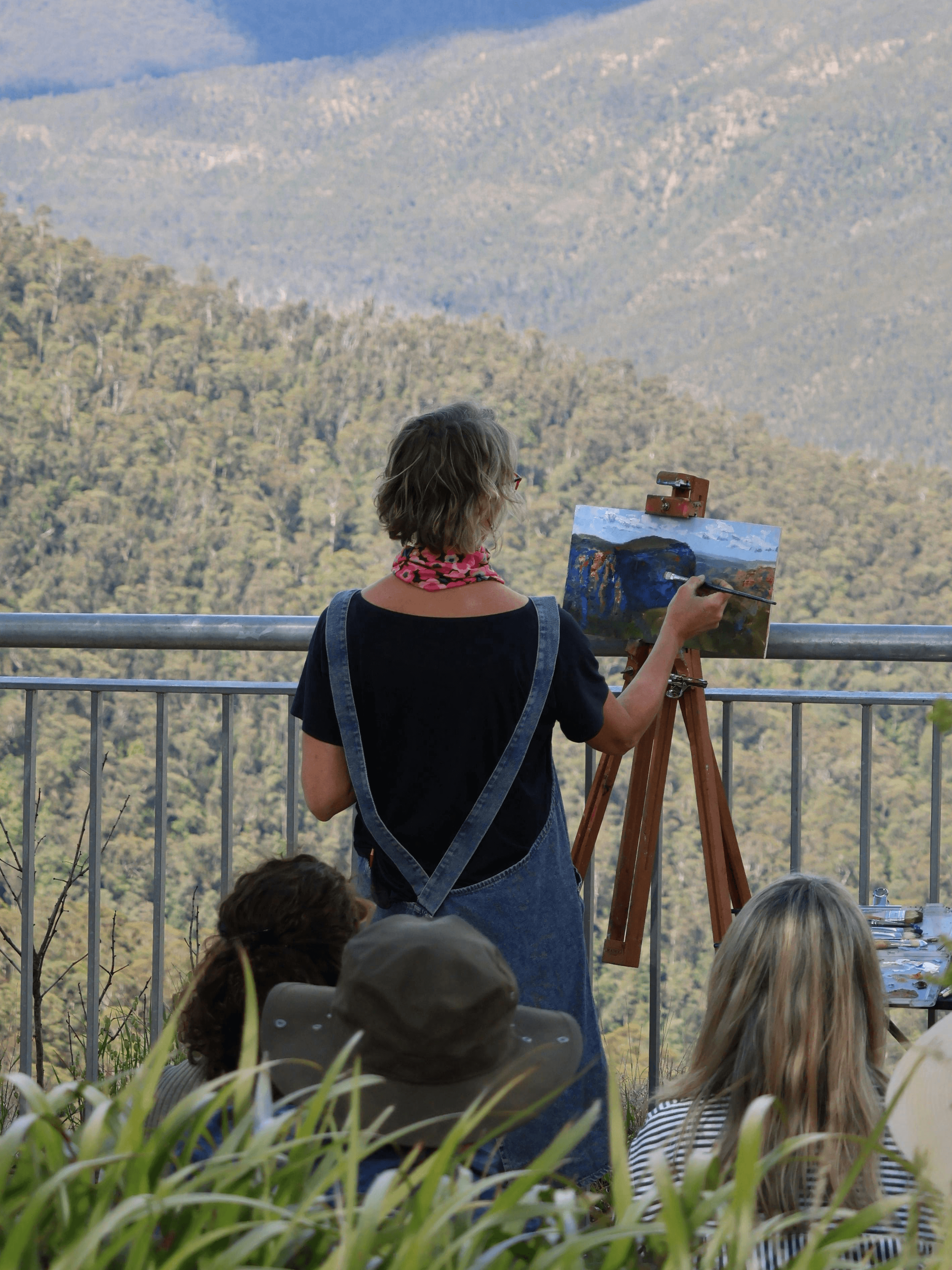 Close-up of a dark green leaf showing its textured surface and central vein against a muted background.