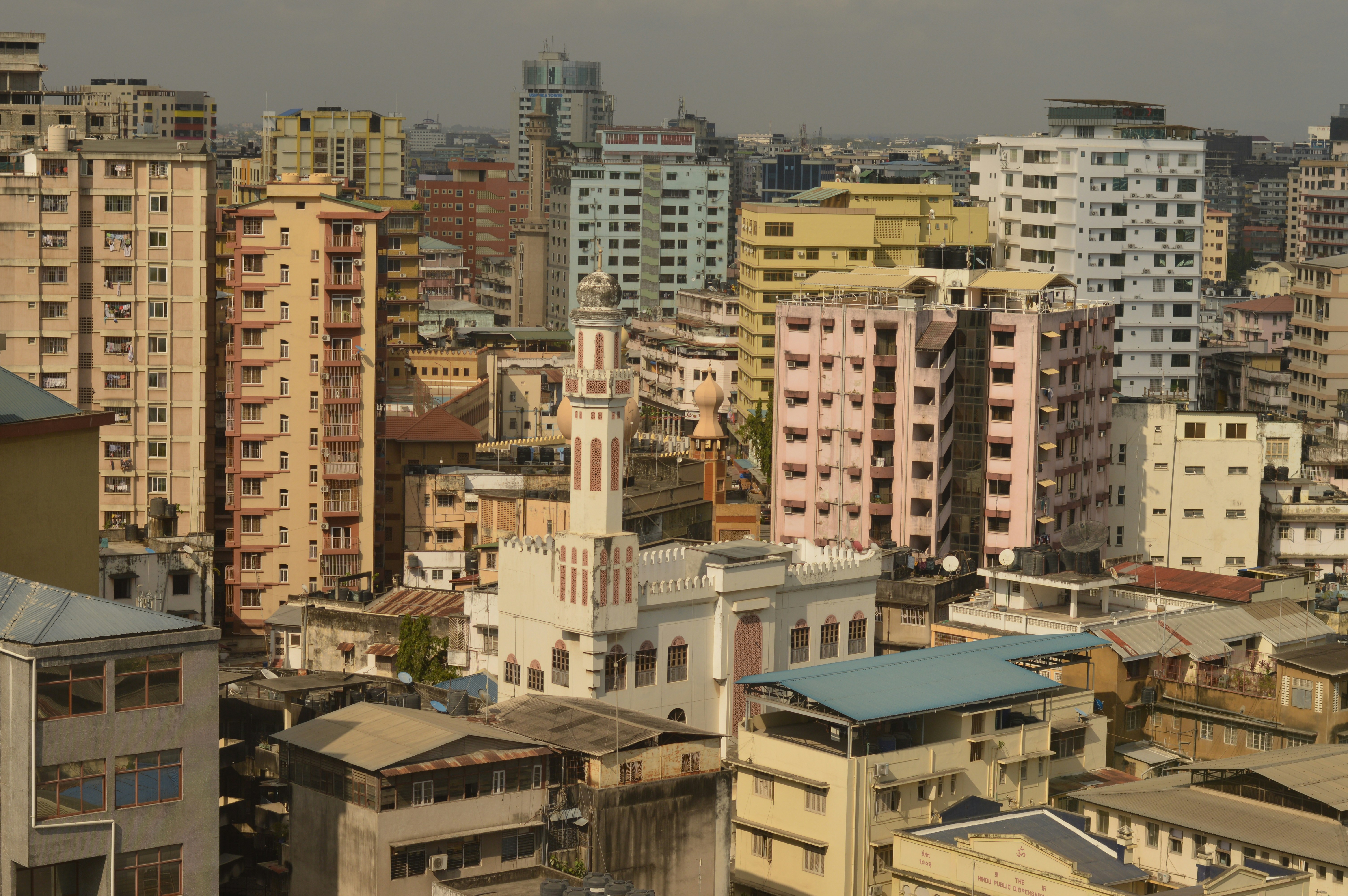 Cityscape with tall buildings and a mosque