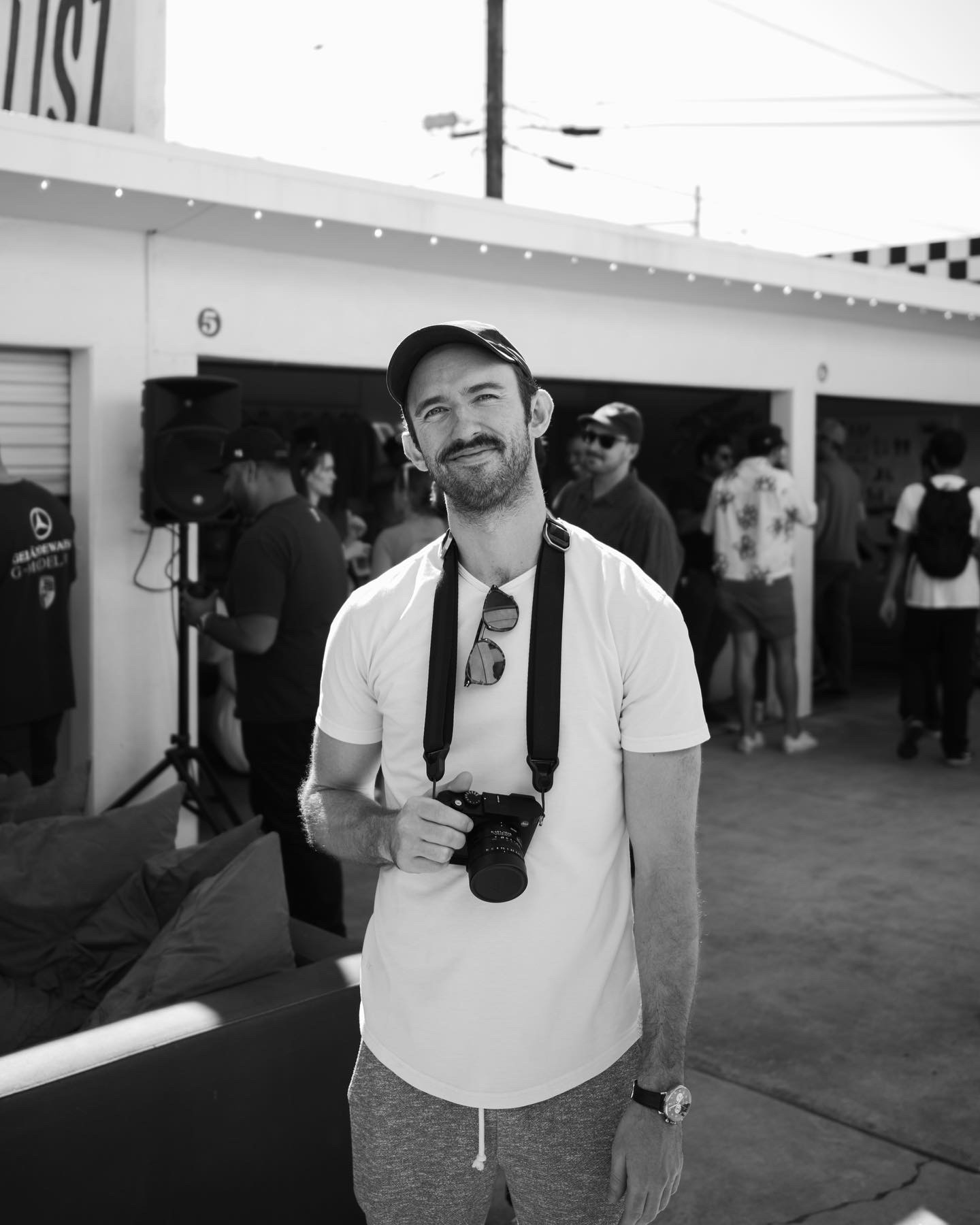 A thoughtful young person with dark hair gazes to the side, captured in soft black and white lighting.