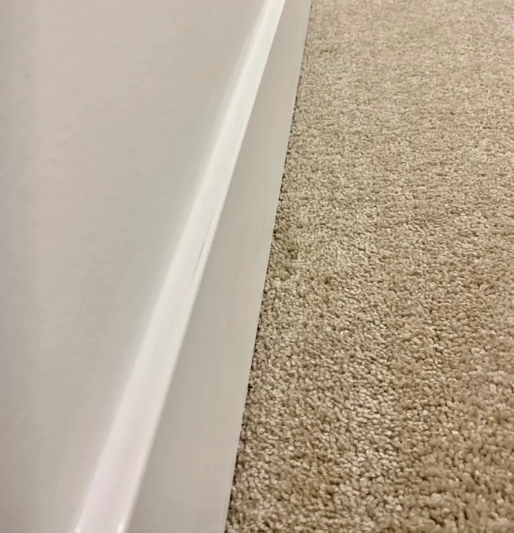 Clean baseboards and carpet after a professional deep clean.