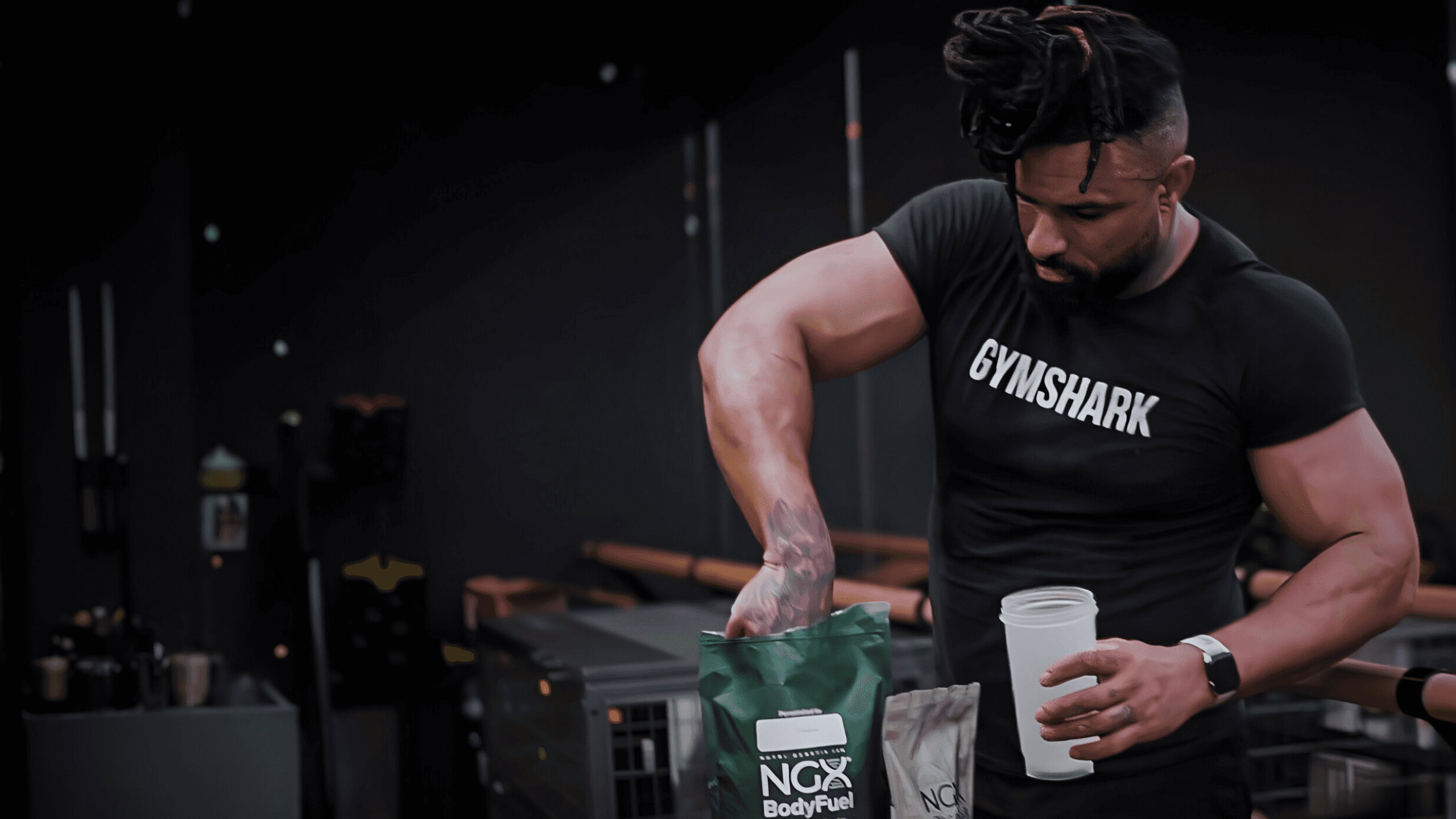 A man with ear buds in a gym