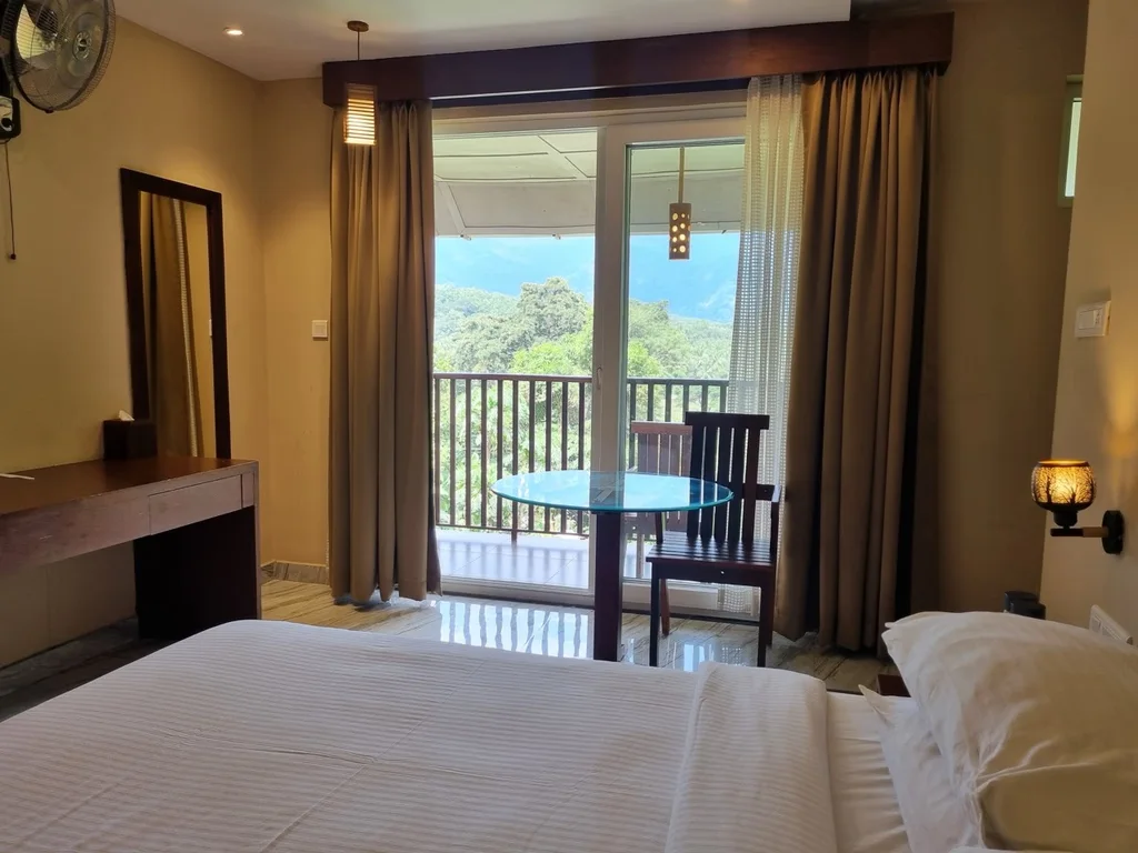 Classic Room at Au Revoir Wellness Resort – Cozy Stay with Modern Amenities and a Scenic Balcony View
