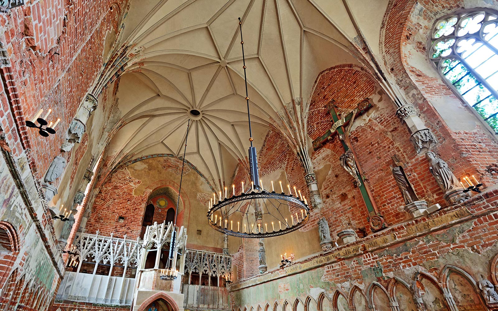 Interior of Malbork Castle chapel with brick walls and vaulted ceiling, seen on a tour from Gdańsk.