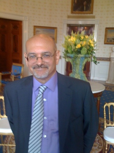 portrait of an older man in a blue suit and tie