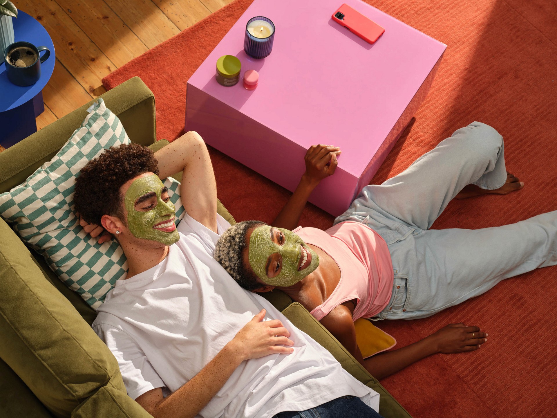 image of a man and a woman sitting on a sofa with a skin face mask