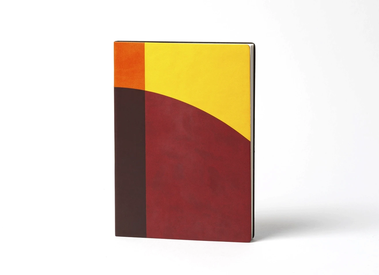 Front view of notebook with abstract red, yellow, and brown design.