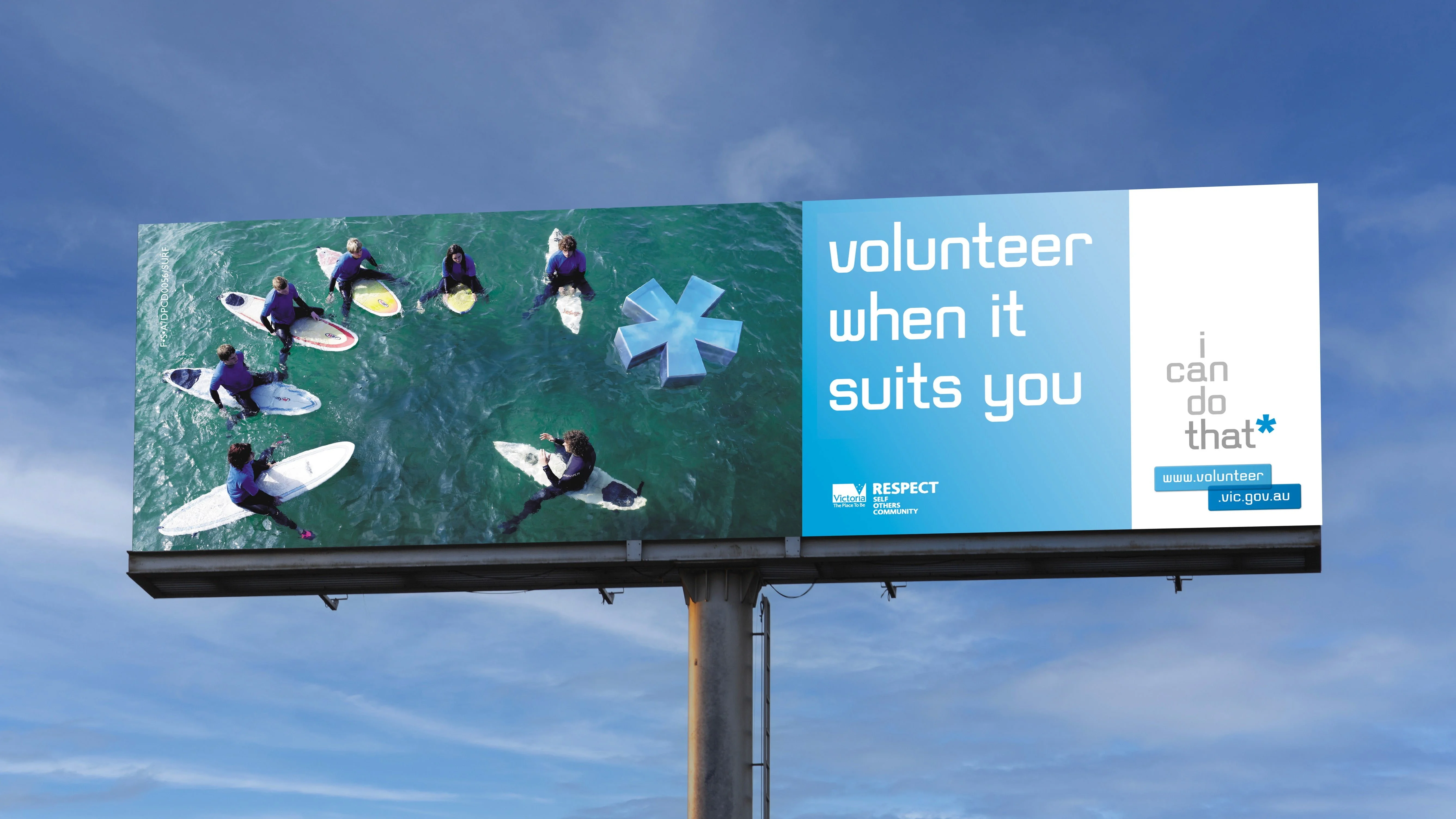 Billboard 'volunteer when it suits you' with surfers in the sea and a blue asterisk, plus the I can do that logo