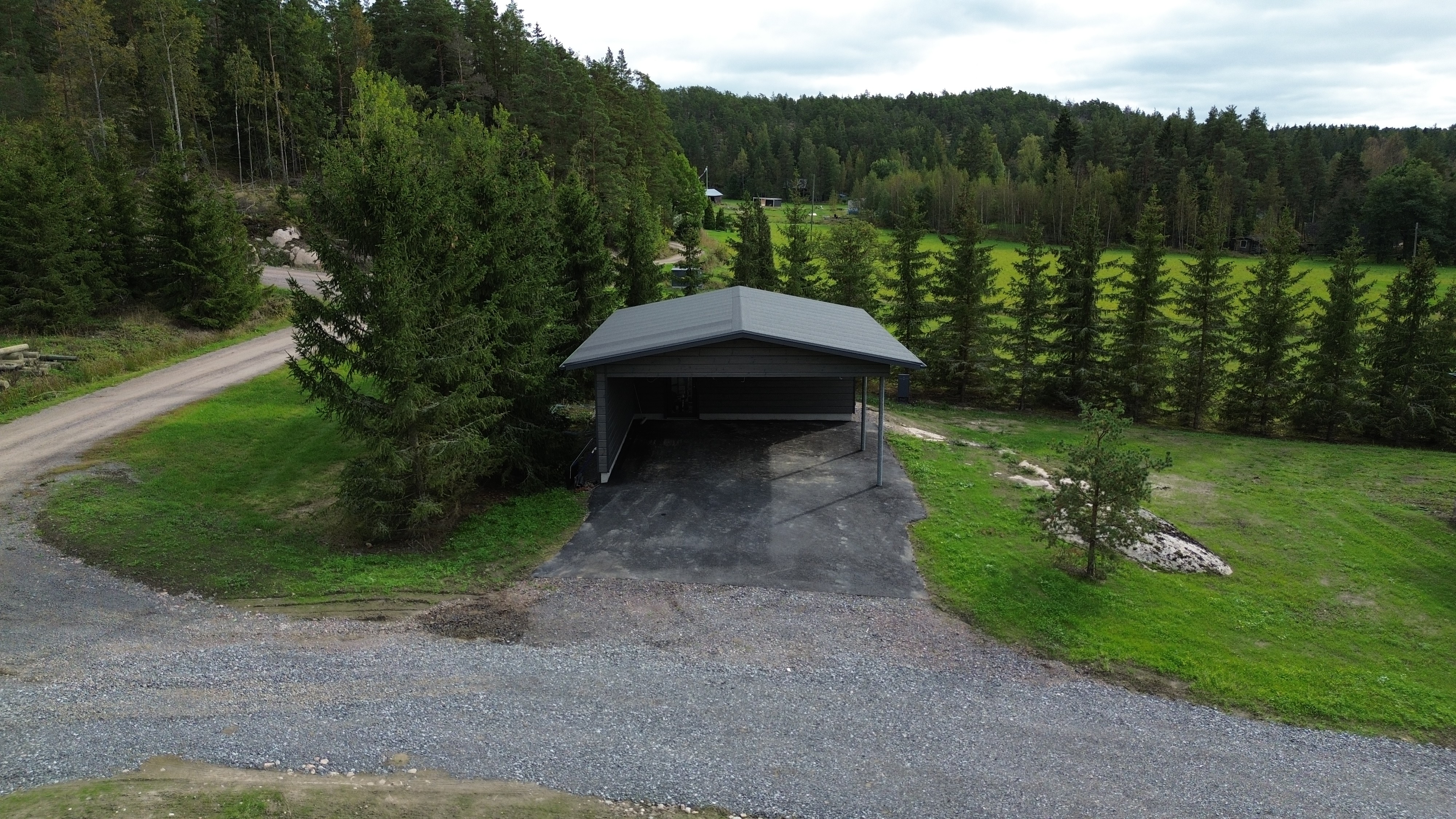 Carport viewed from the front. Paved road