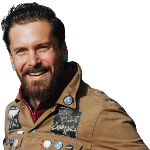Headshot of a smiling man with a beard and an aviator jacket