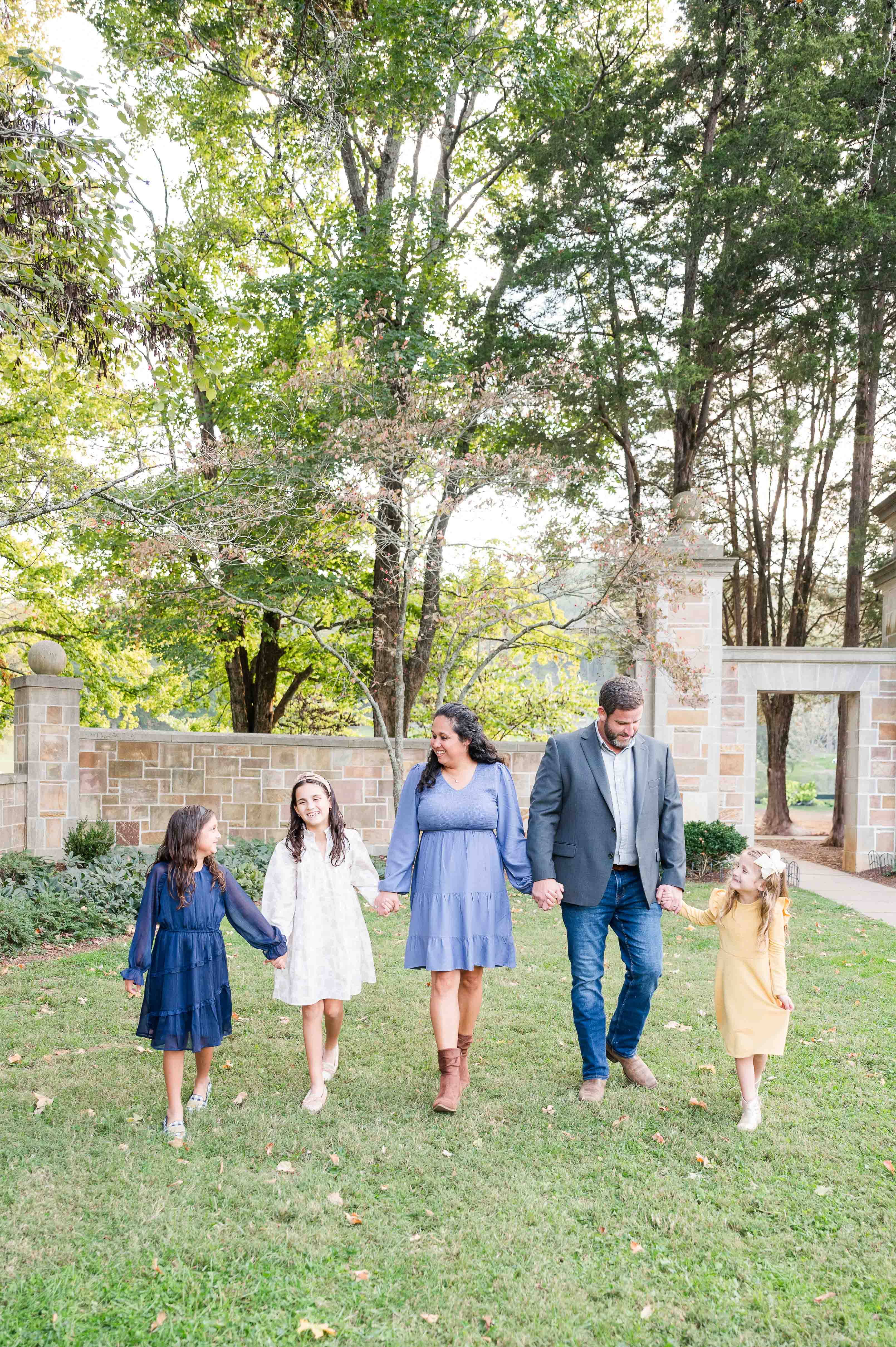 Family mini session at Percy Warner Park family holding hands and walking.
