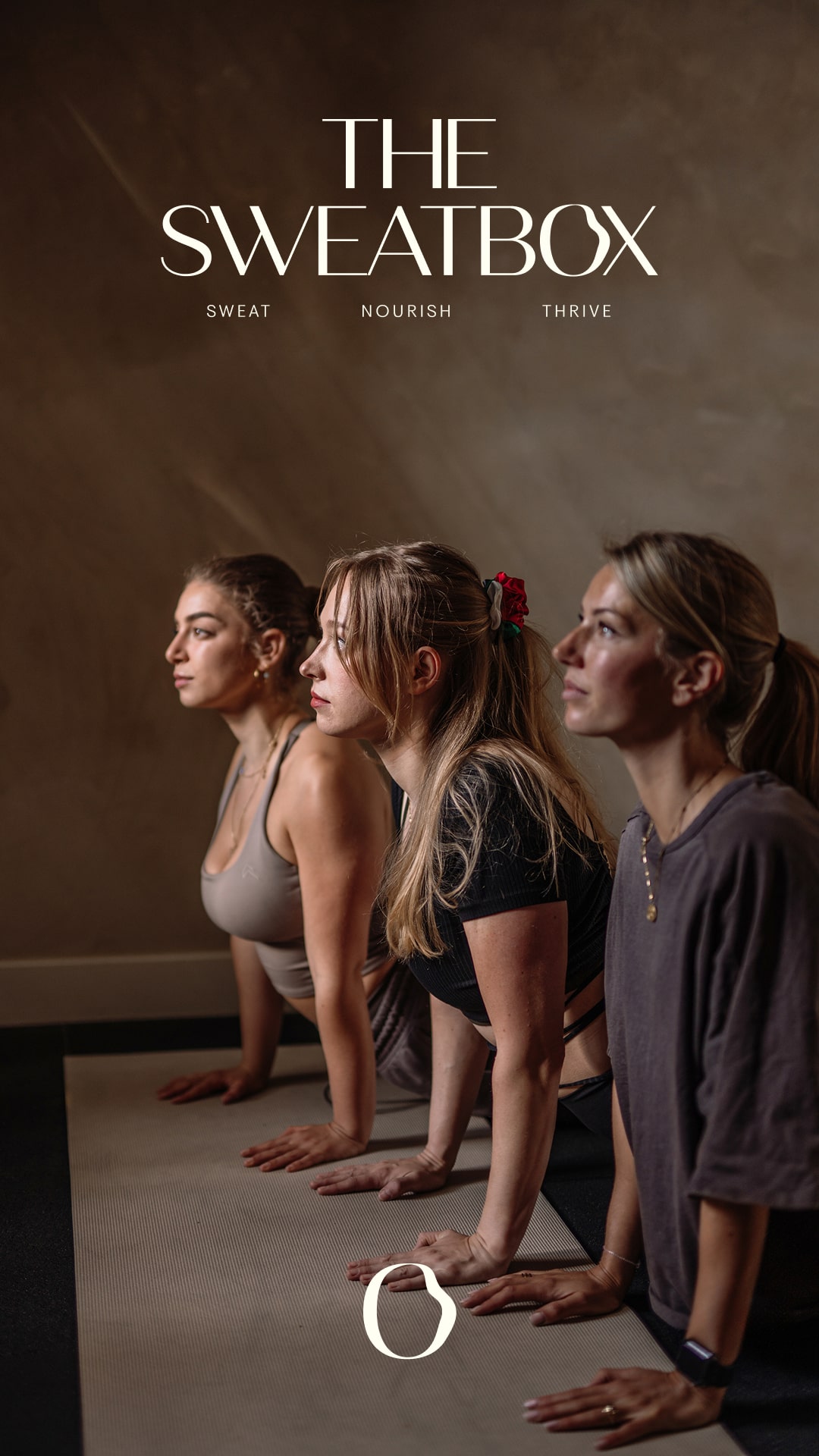 A serene spa setting with two lounge chairs beside a warm, reflective pool and soft, natural lighting.